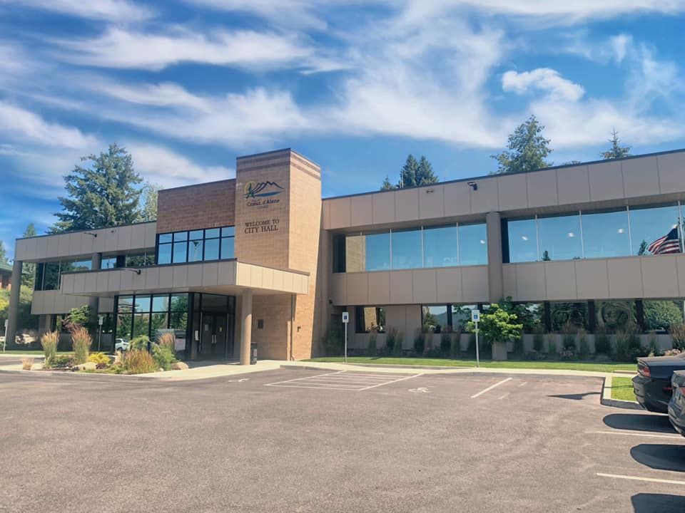 A large building with a lot of windows and a truck parked in front of it.