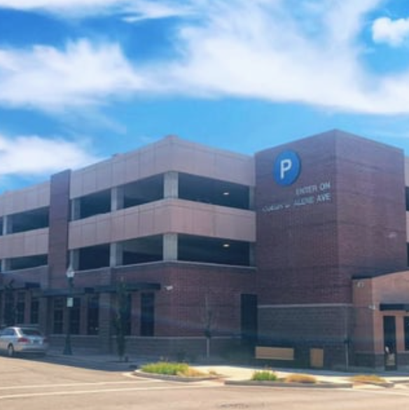 A parking garage with a blue p on the side of it