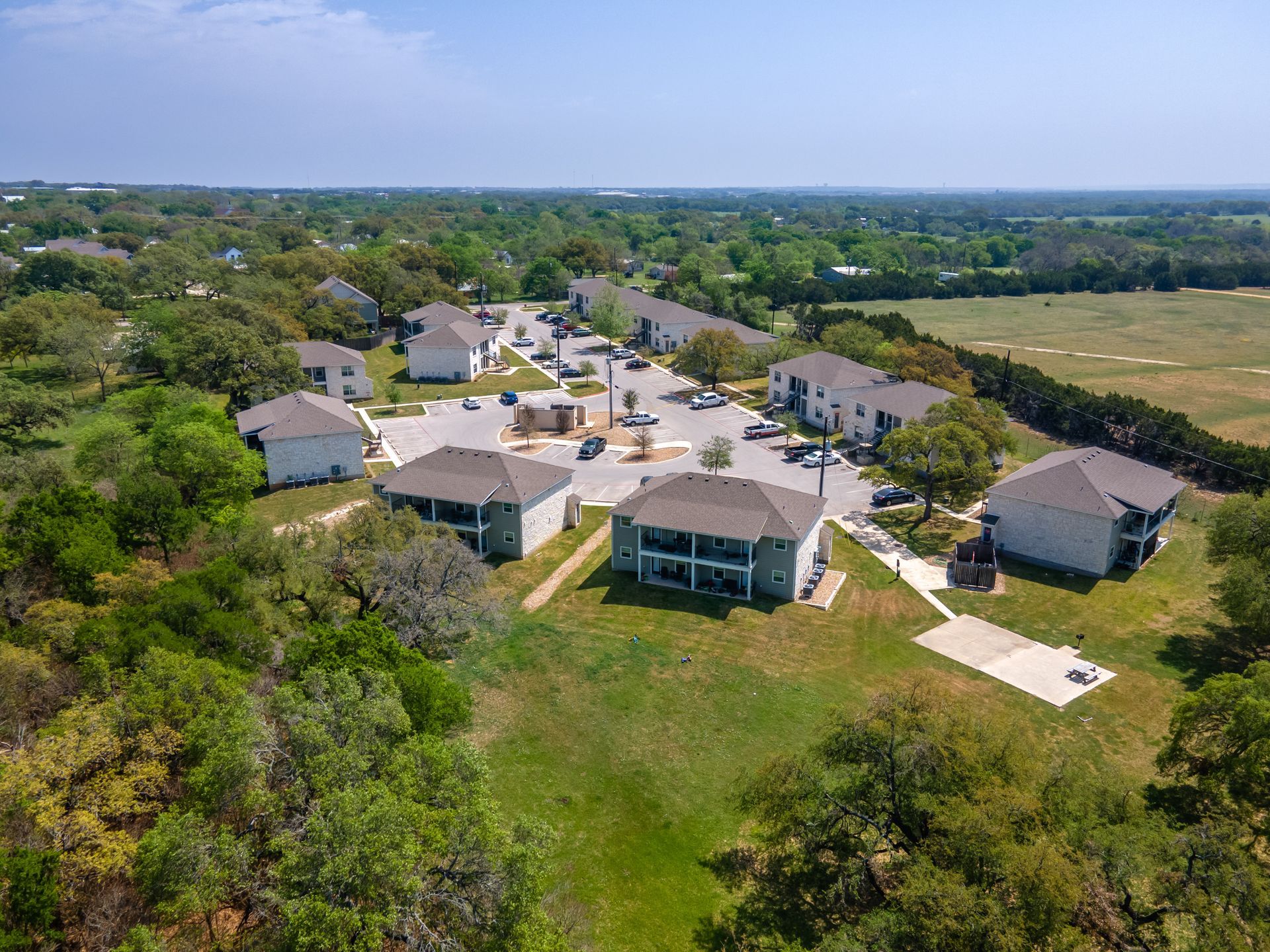 An aerial view of a residential area with houses and trees.
