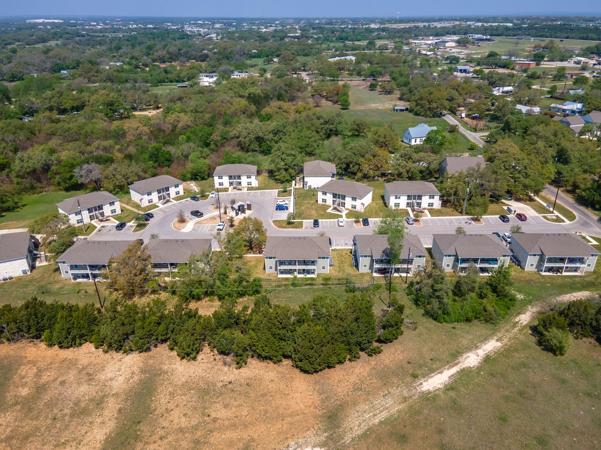 An aerial view of a residential area with houses and trees