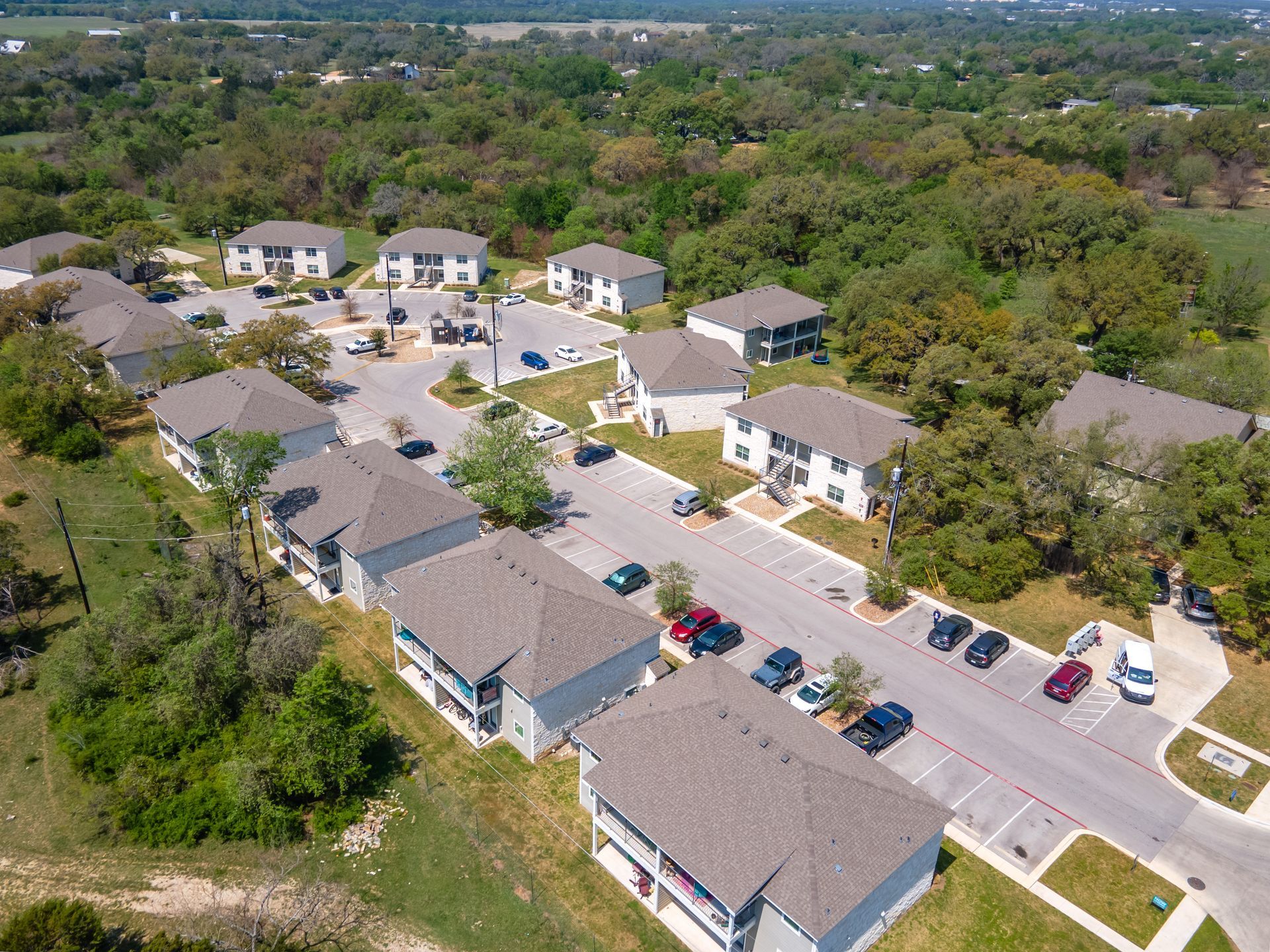 An aerial view of a residential area with lots of houses and trees.