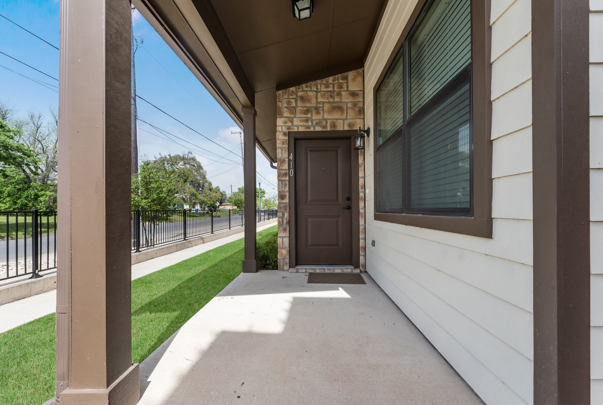A house with a porch and a brown door