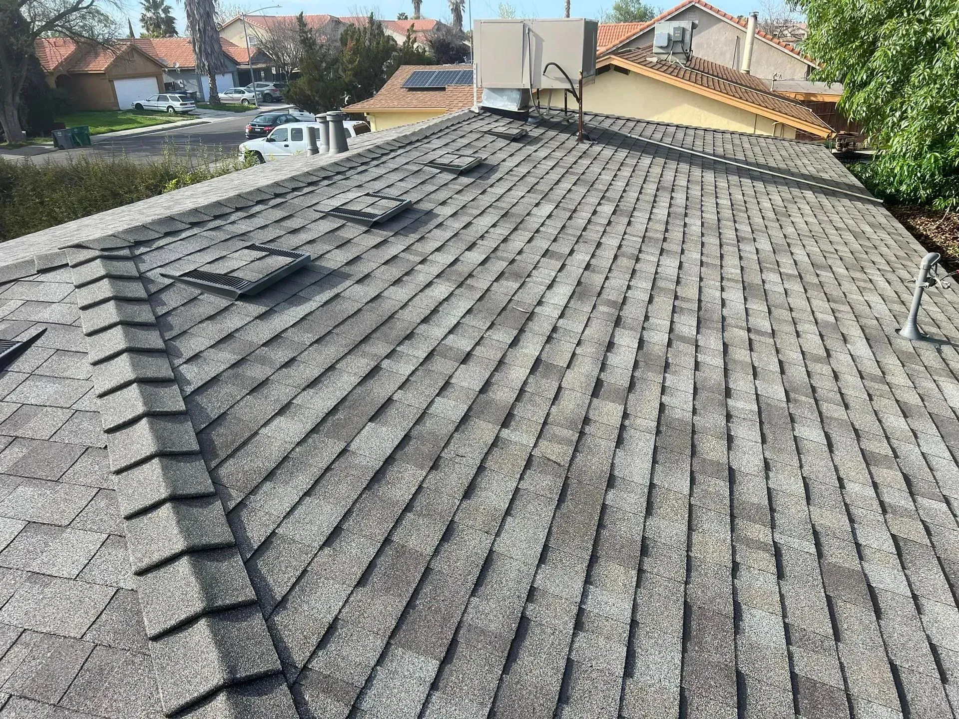 The roof of a house has a lot of shingles on it.