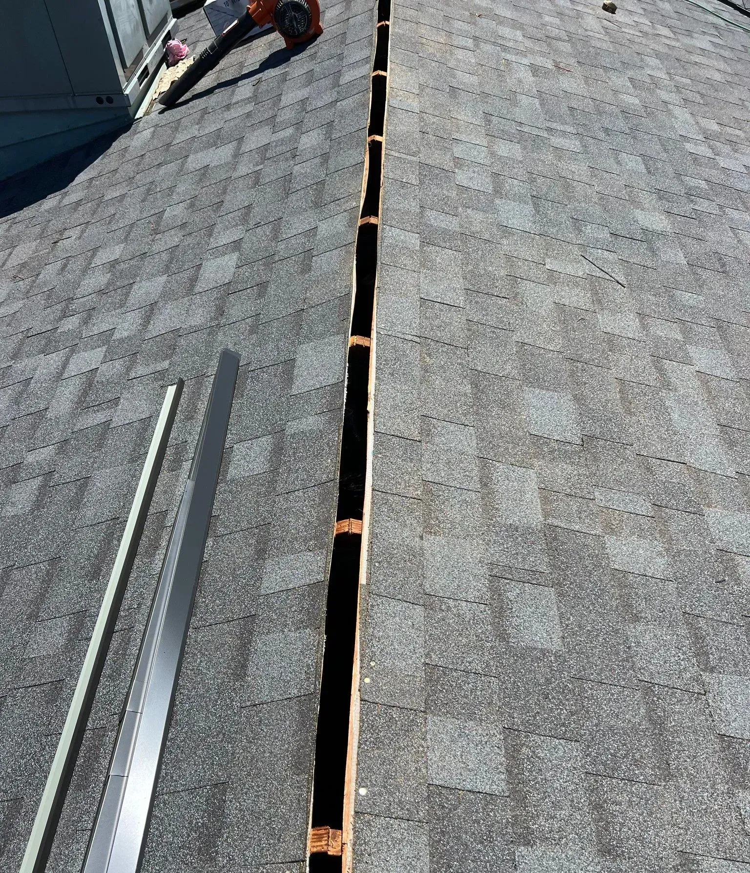A roof with a row of shingles being installed on it.
