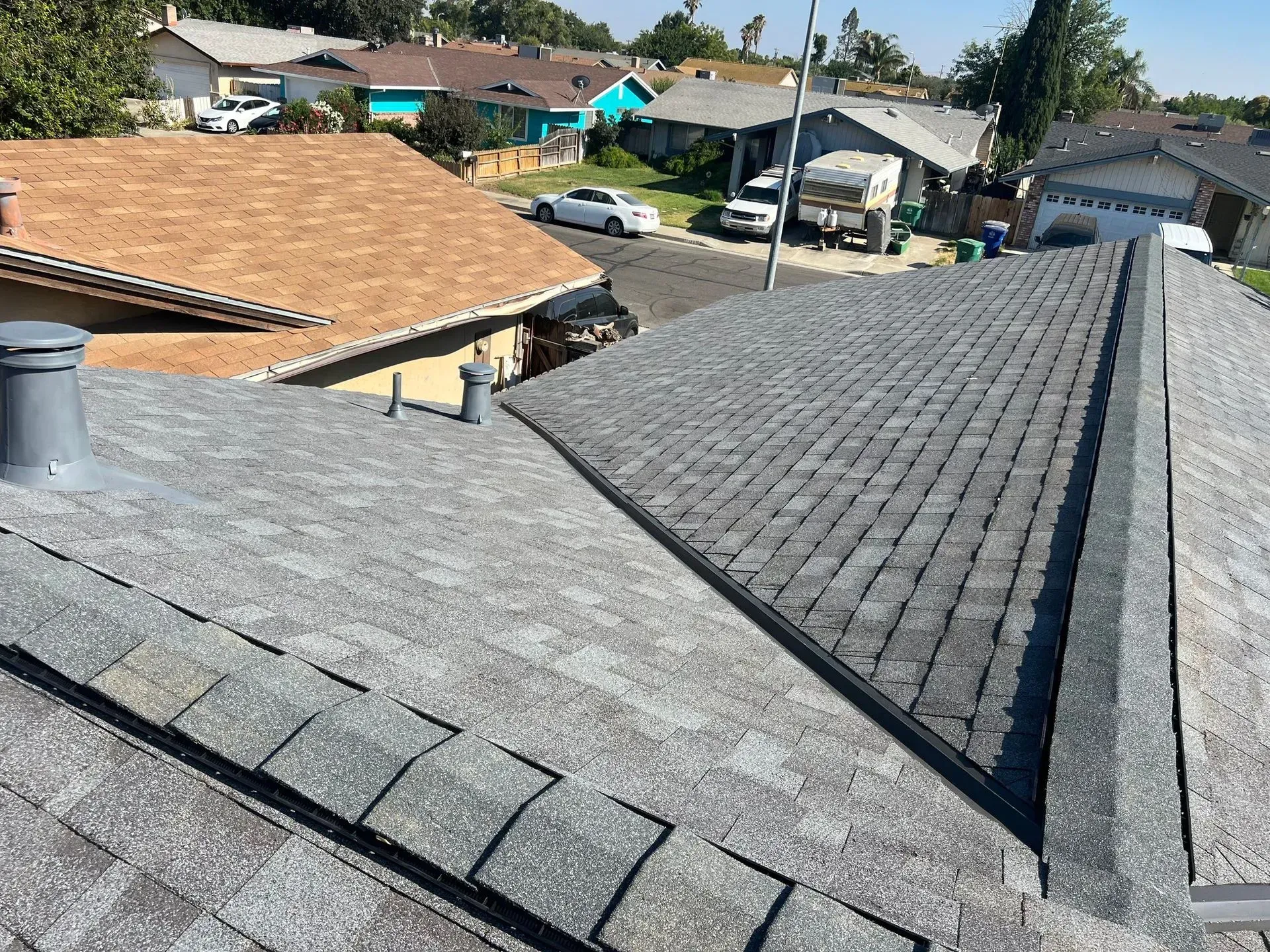 A roof with a lot of shingles on it in a residential area.