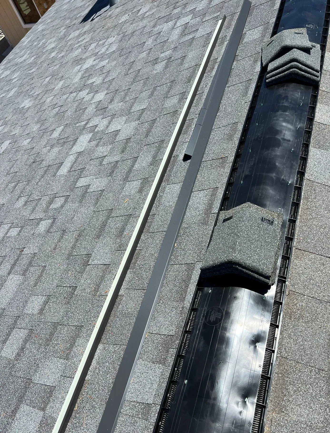 A close up of a roof with a drain on it.