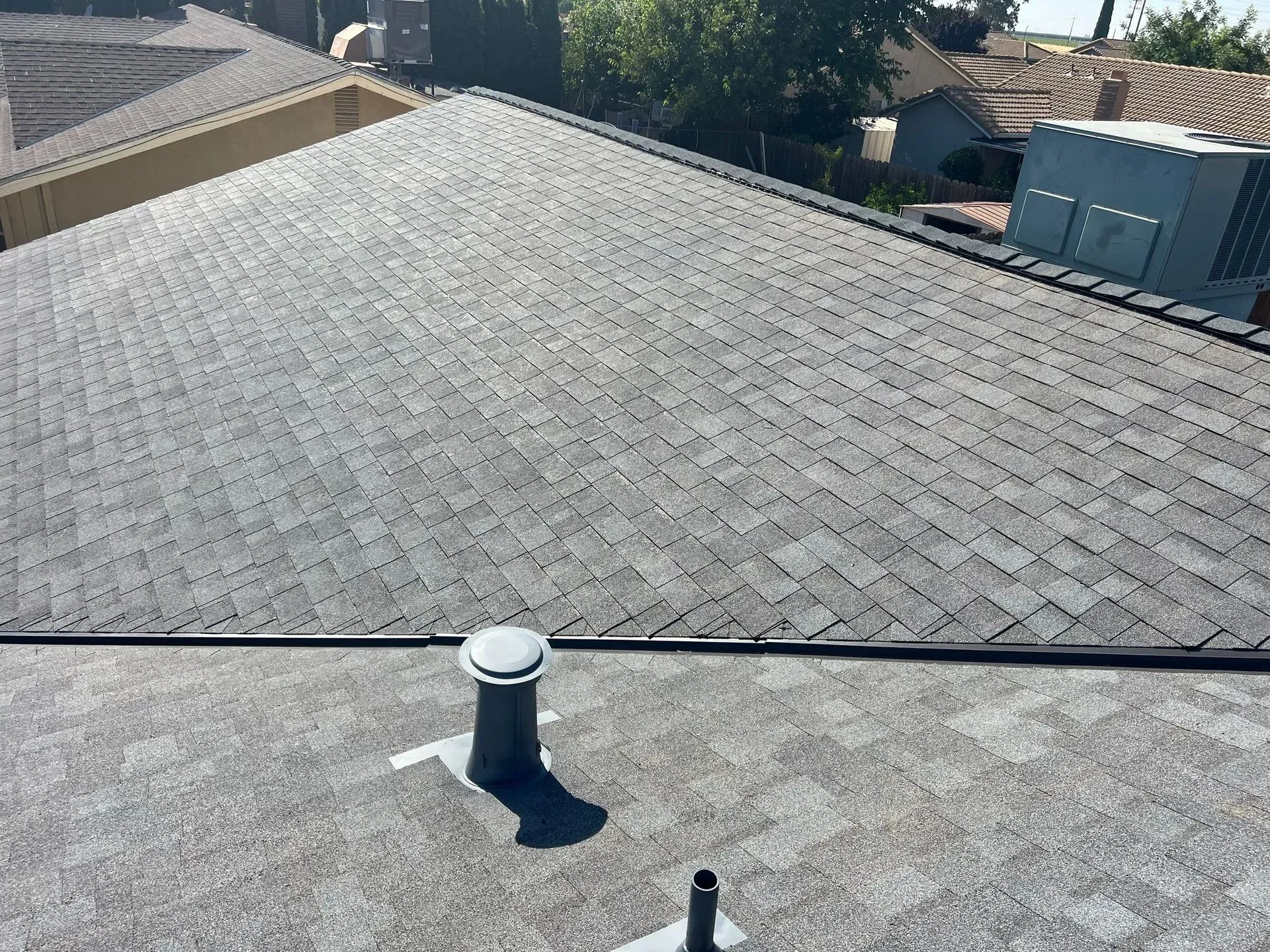The roof of a house with a chimney on it.
