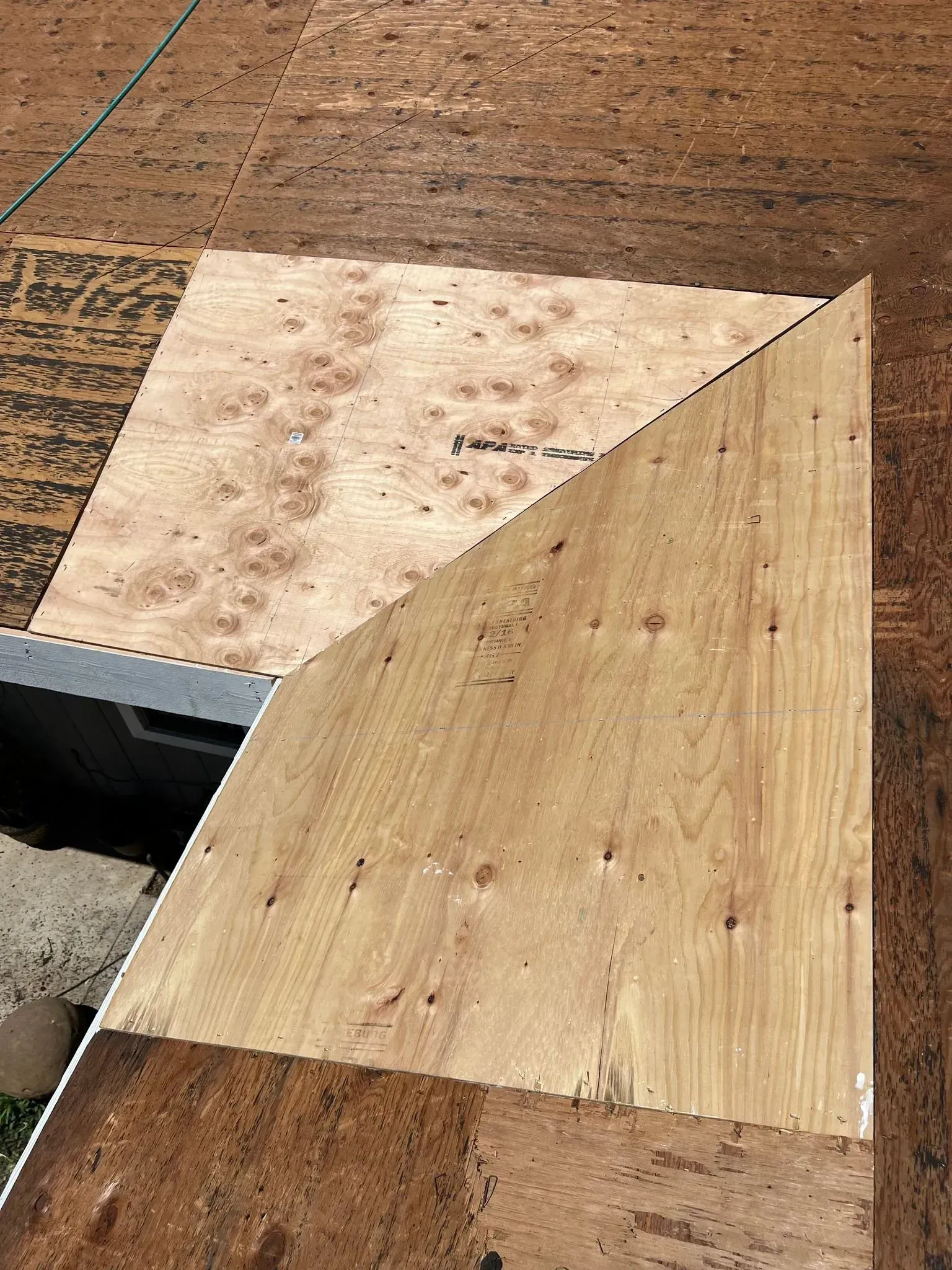 A piece of plywood is sitting on top of a wooden table.