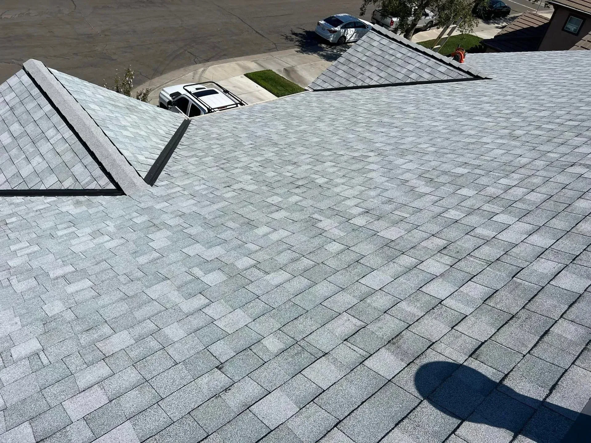 A roof with a lot of shingles and a car parked on it.