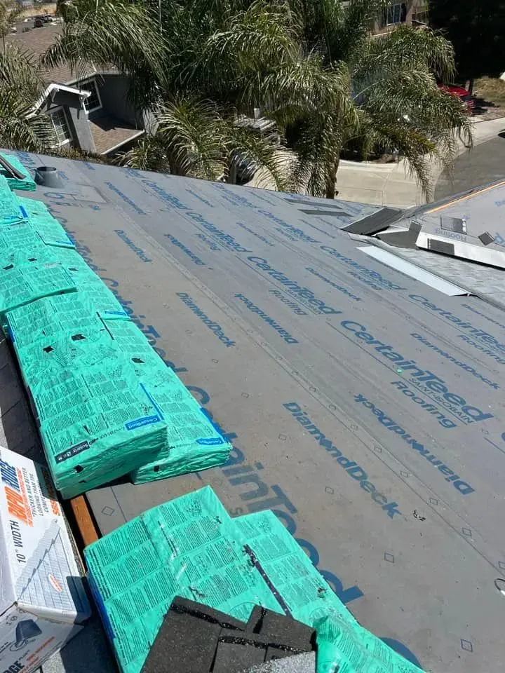 A roof with a lot of green sheets on it.