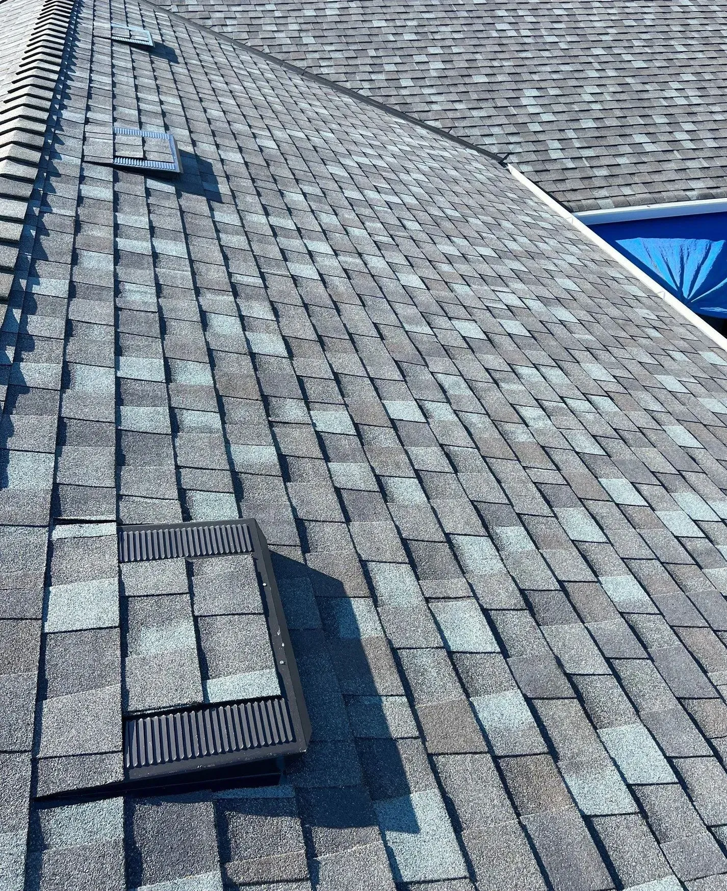 A close up of a roof with a drain on it.