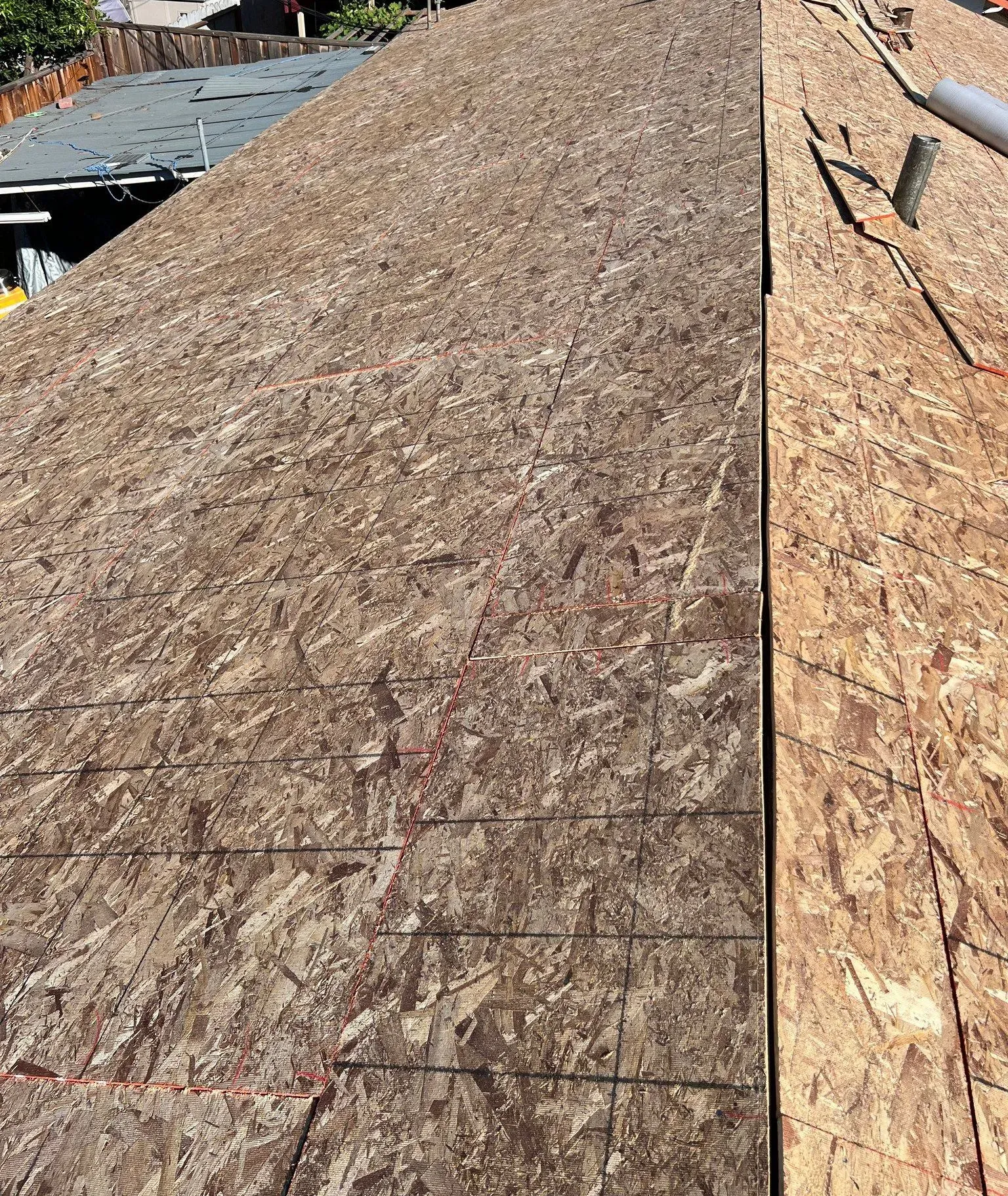A close up of a roof with a lot of plywood on it.