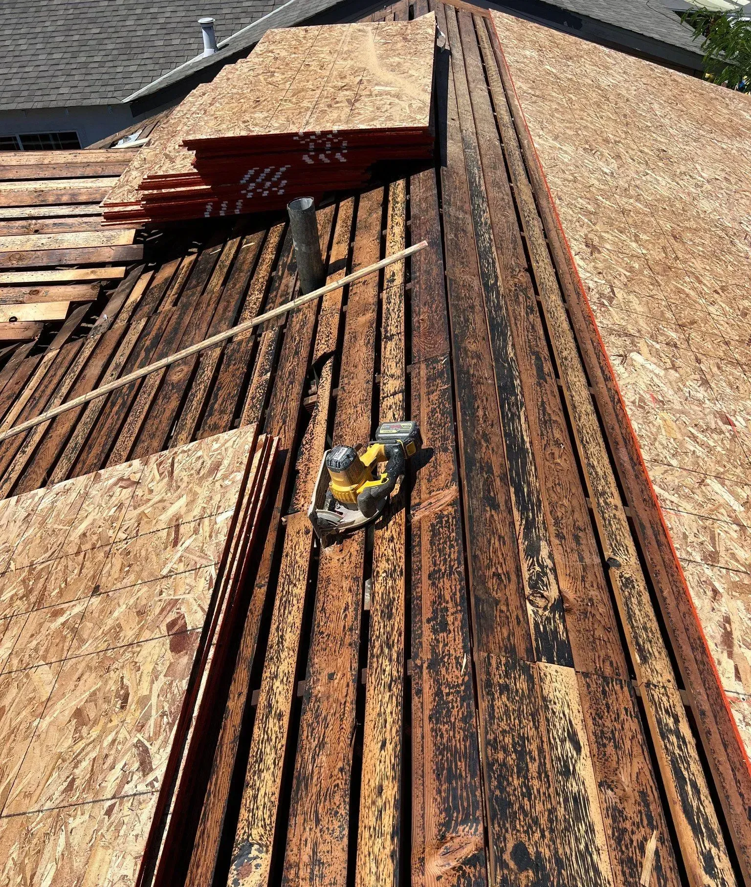 A roof with wooden beams and a drill on it.