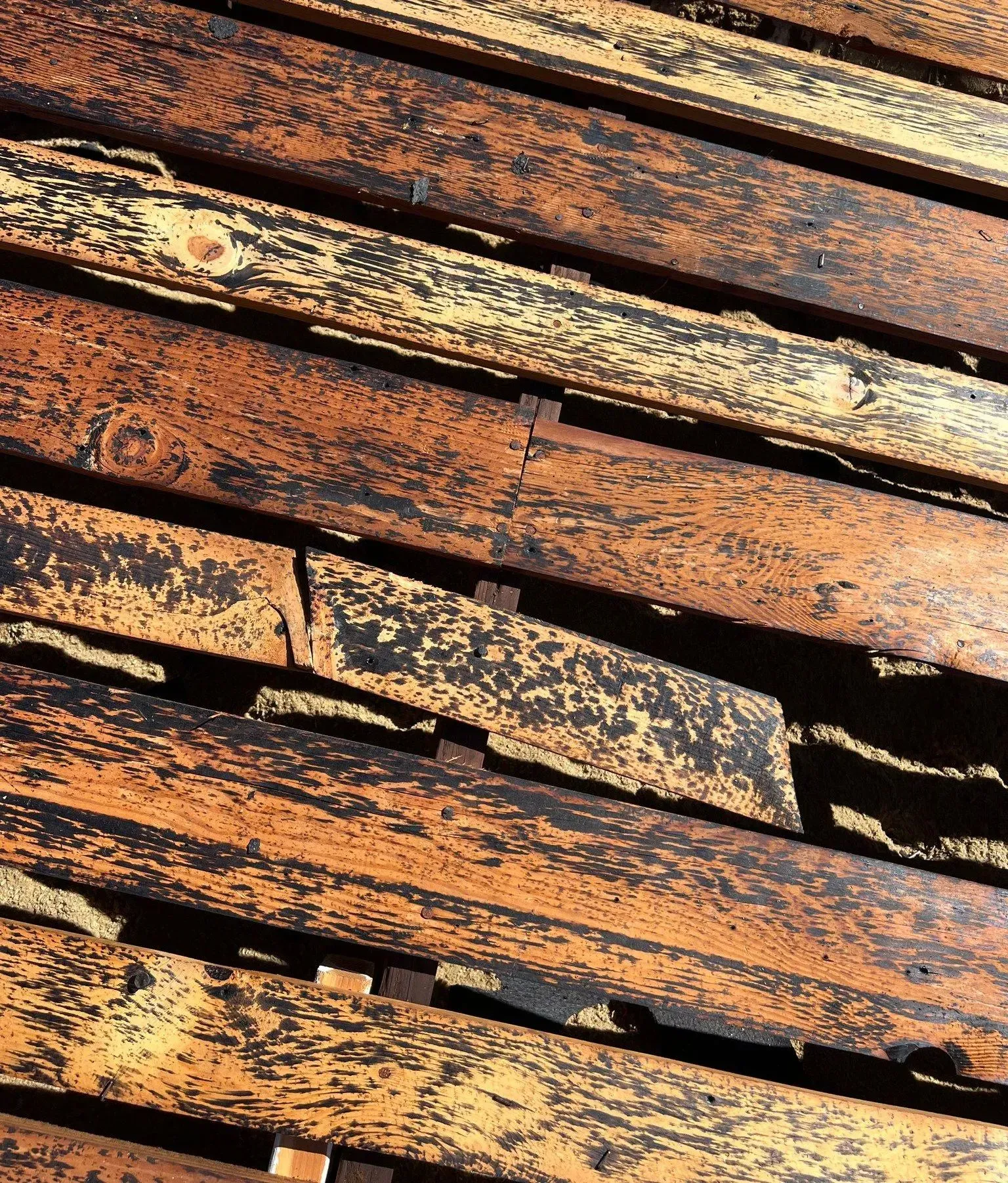 A close up of a wooden floor with a lot of stains on it