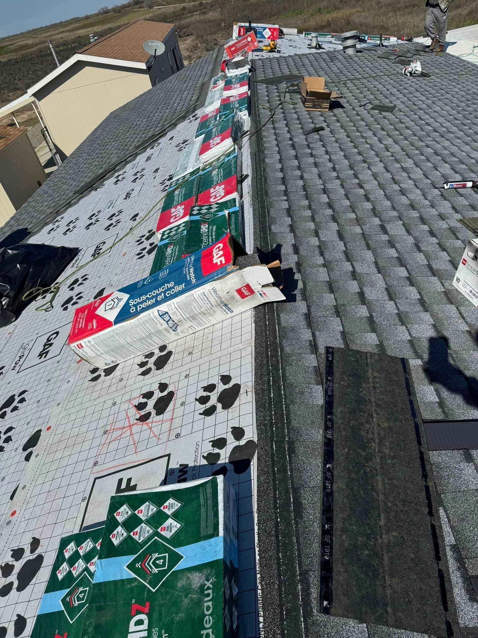 A roof with a lot of shingles being installed on it.