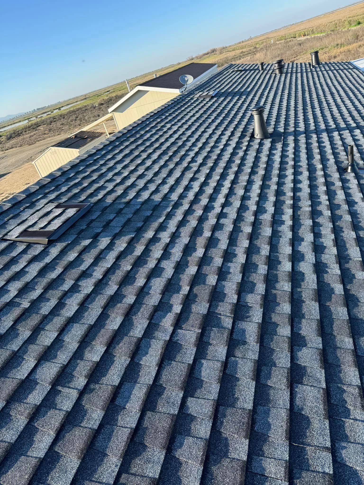 A close up of a roof with a lot of shingles on it.