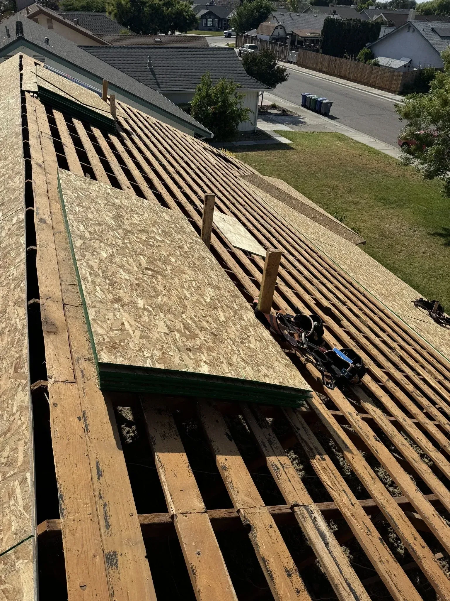 The roof of a house is being remodeled with wooden beams.