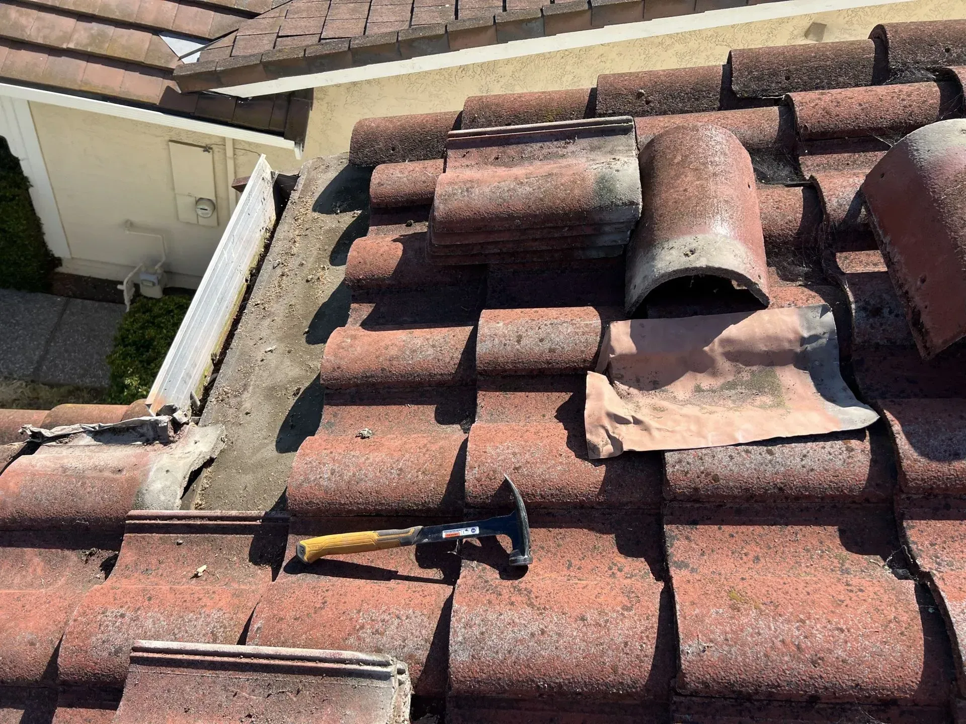 A roof with a hammer sitting on top of it.