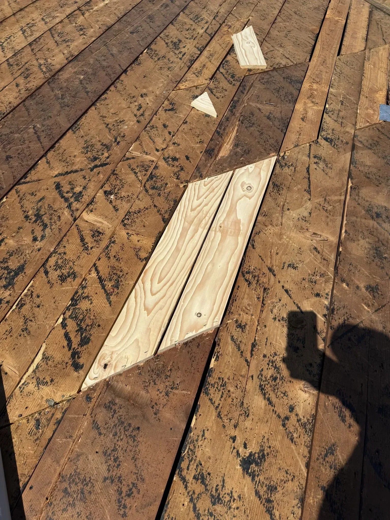 A piece of wood is sitting on top of a wooden deck.
