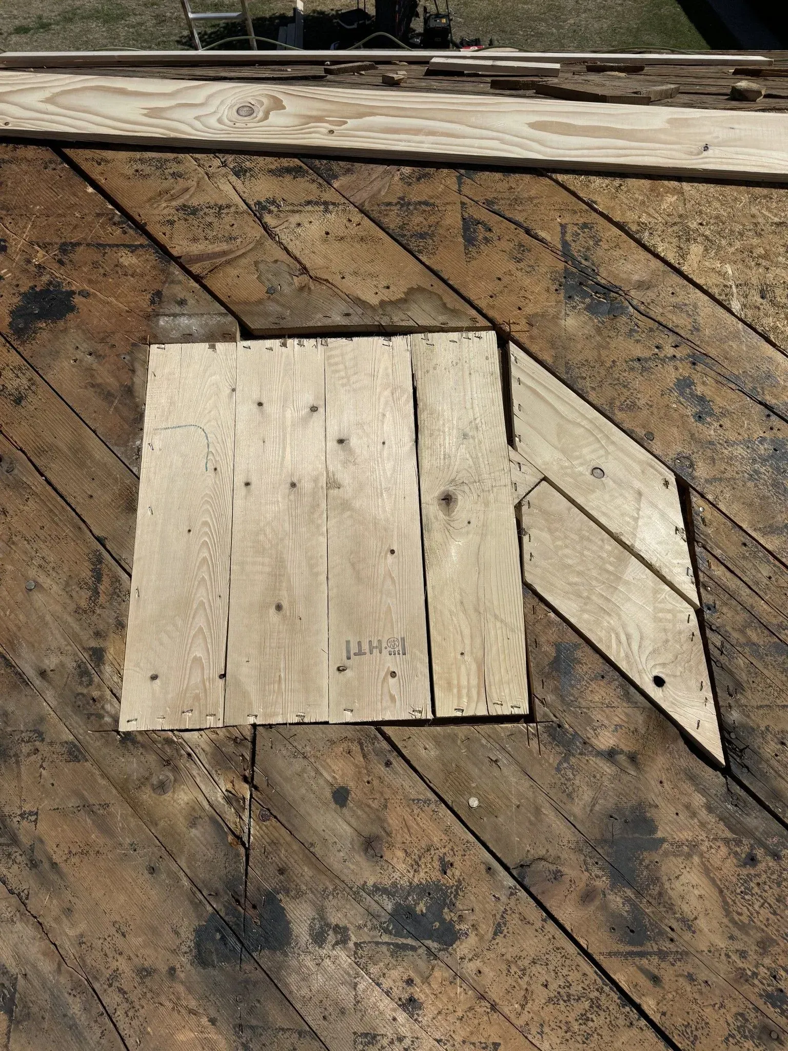 A piece of wood is sitting on top of a wooden floor.