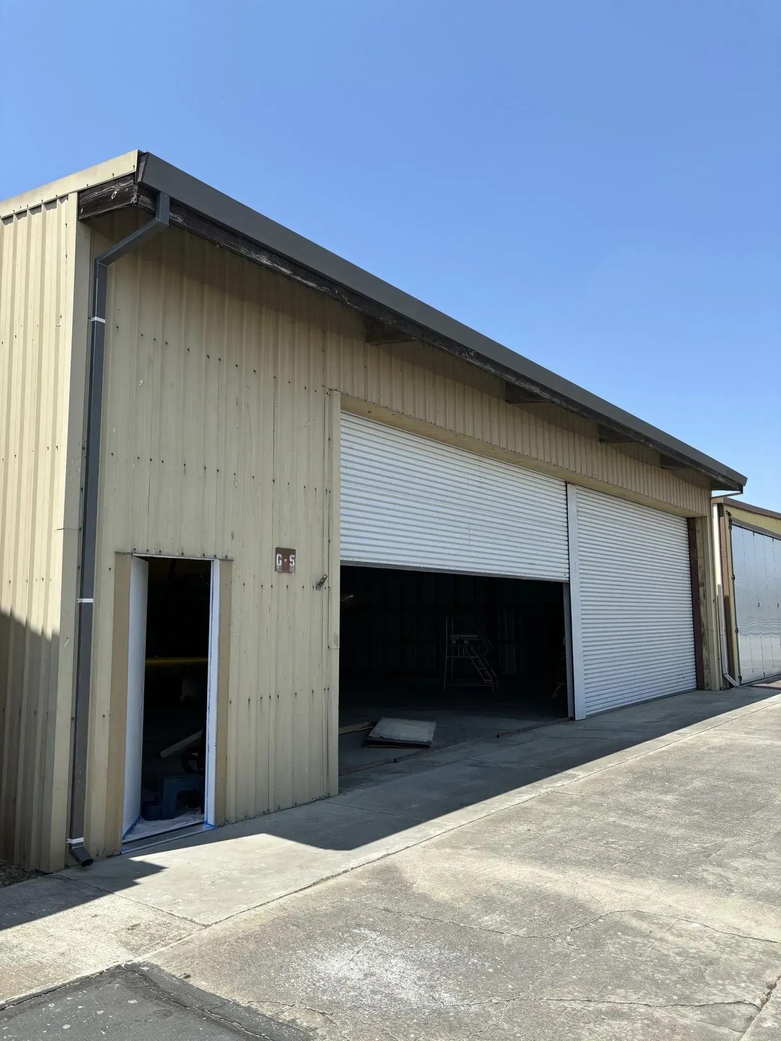 A large building with a large garage door open.