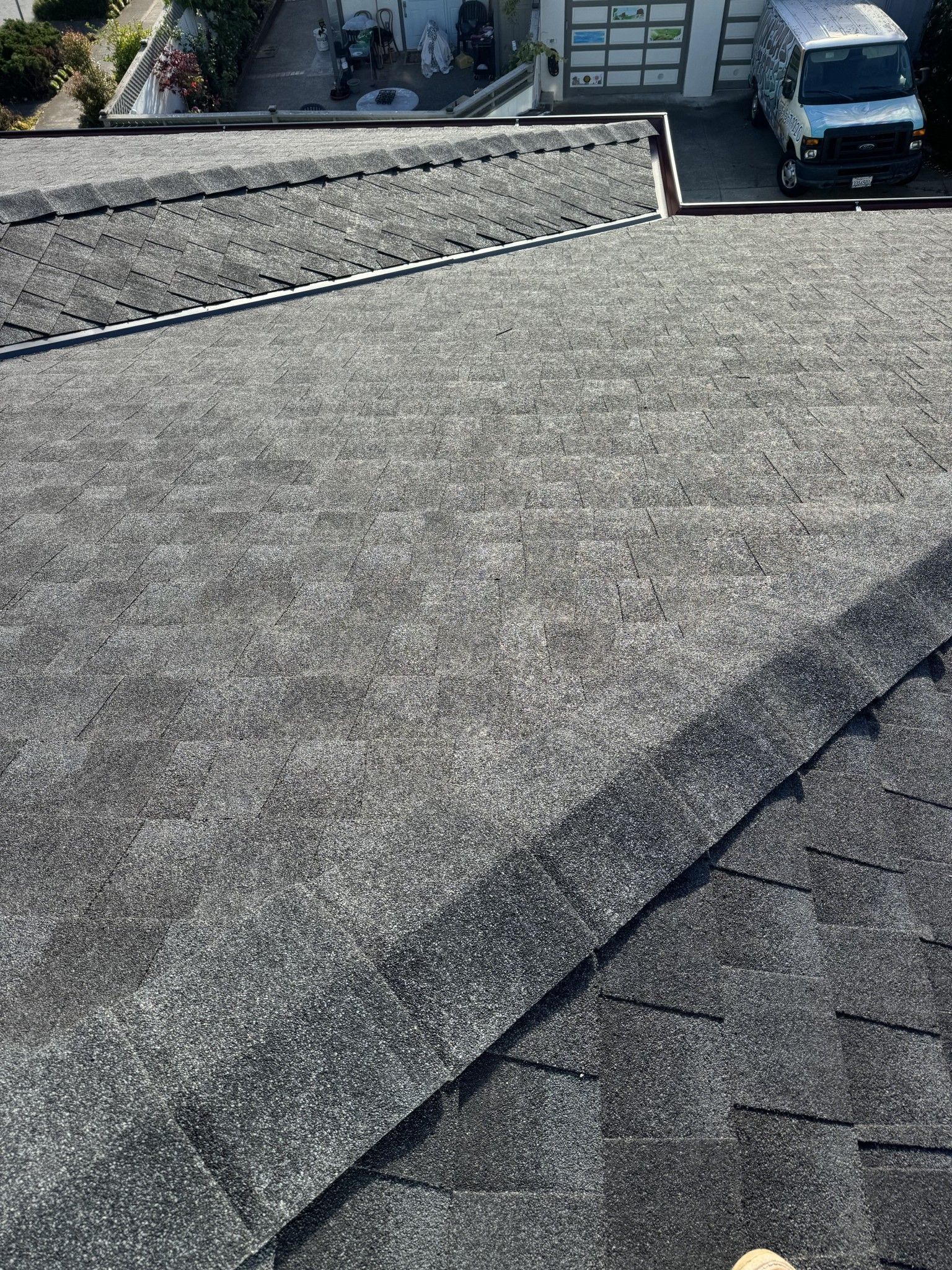 A van is parked on the roof of a house.