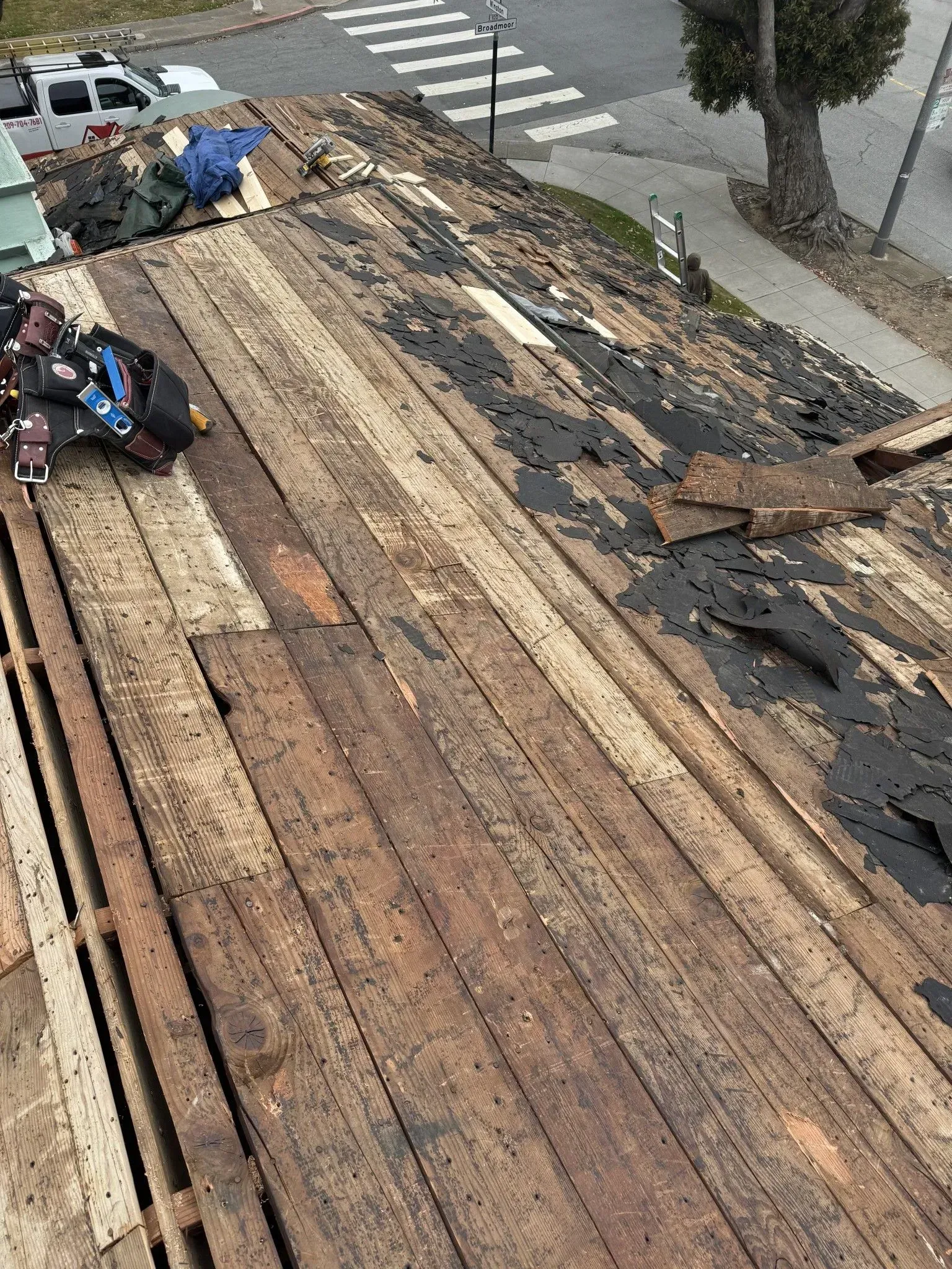 A wooden roof is being removed from a building.