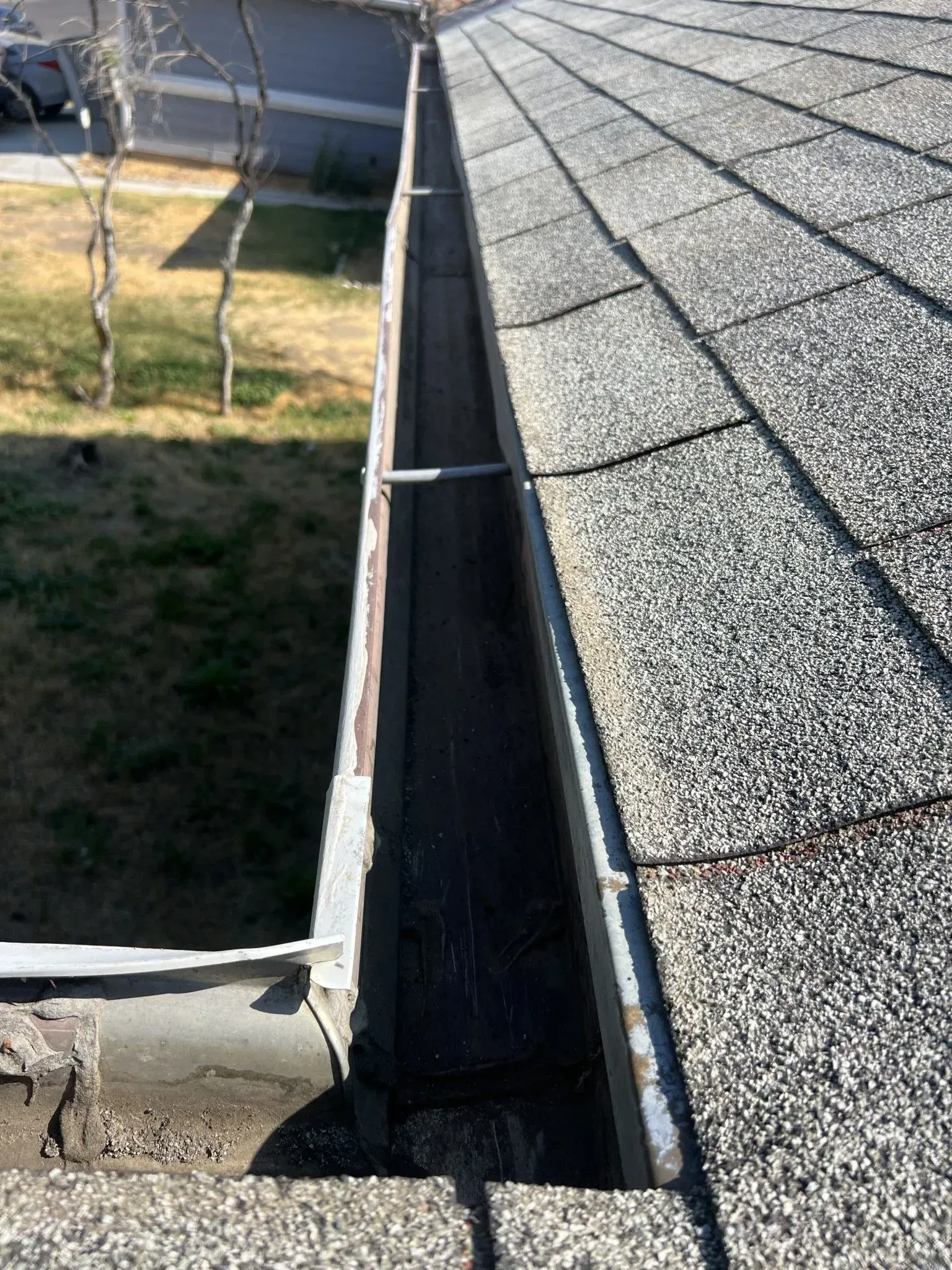 A close up of a gutter on the side of a roof.