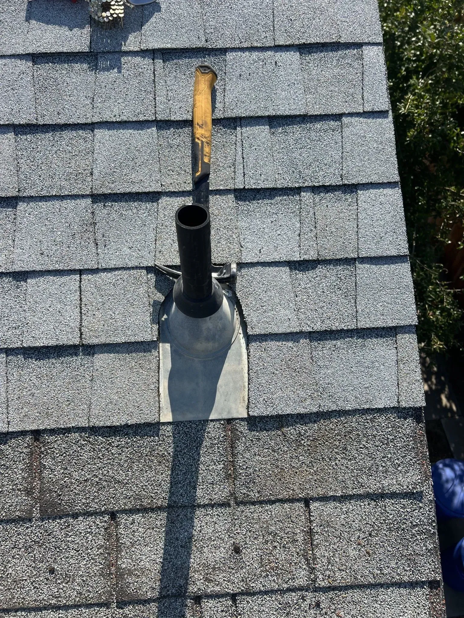 An aerial view of a roof with a chimney on it.