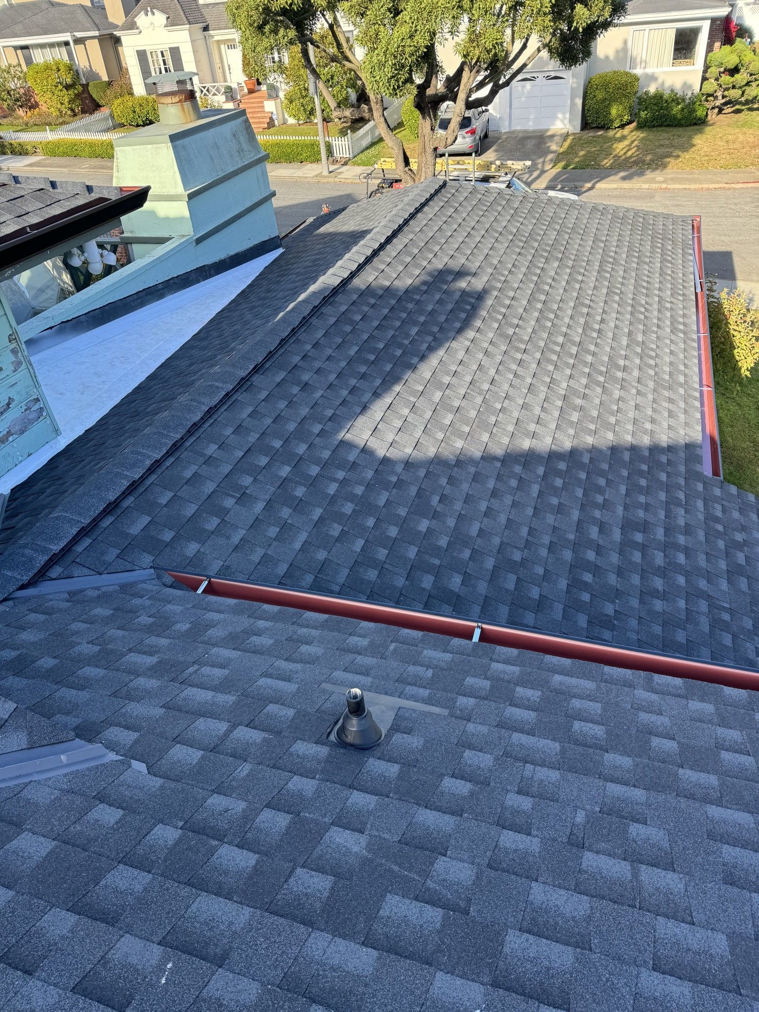 A close up of a roof with a chimney on it.