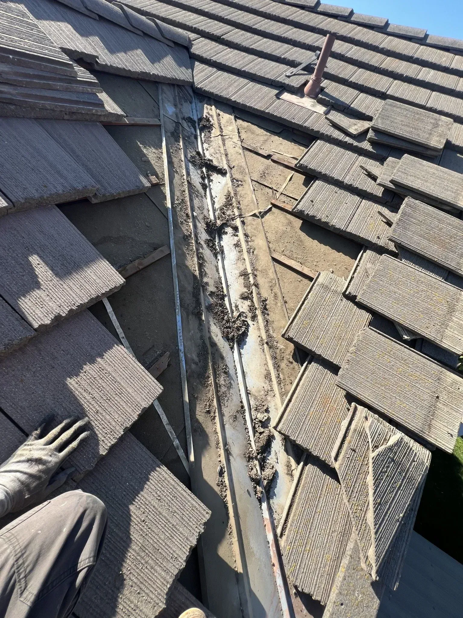 A person is working on the roof of a house.
