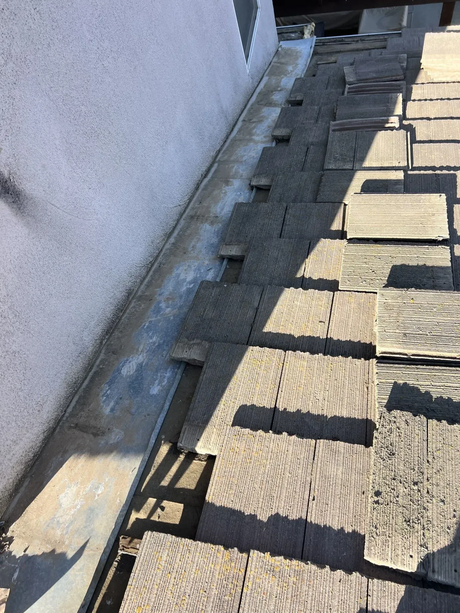 A close up of a roof with a lot of shingles on it.