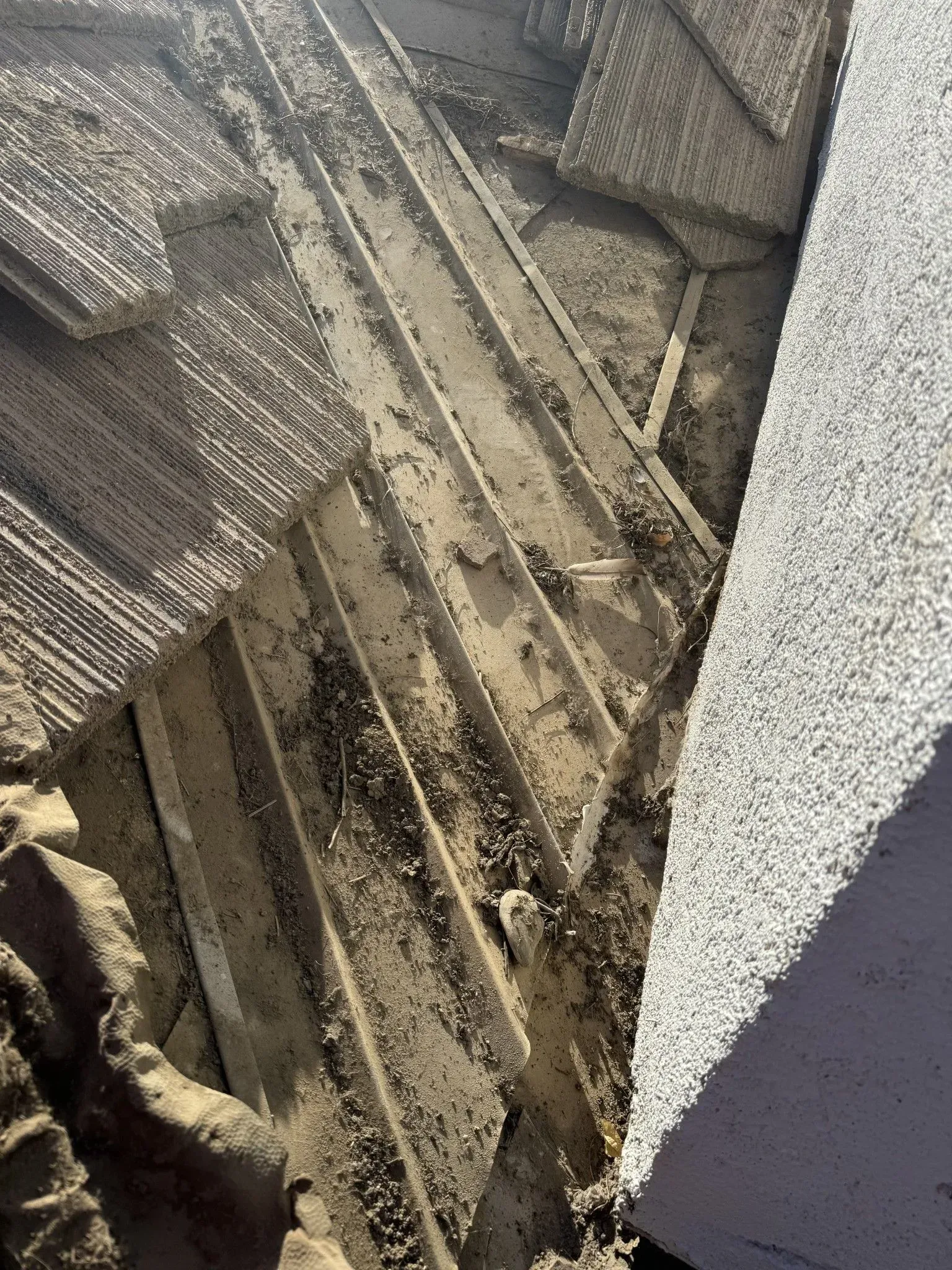 A pile of wood and concrete is laying on the ground.