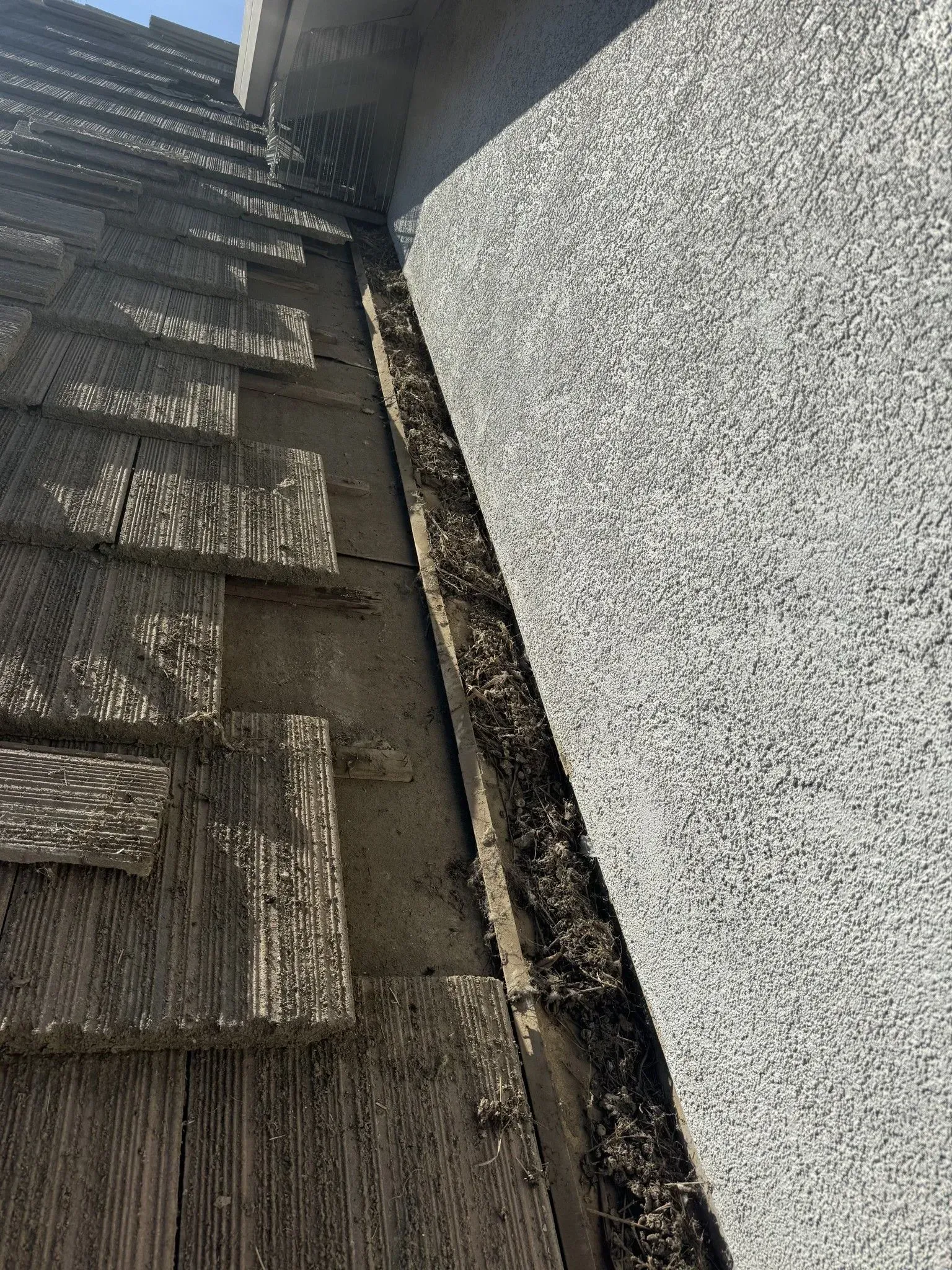 A close up of a gutter on the side of a building.