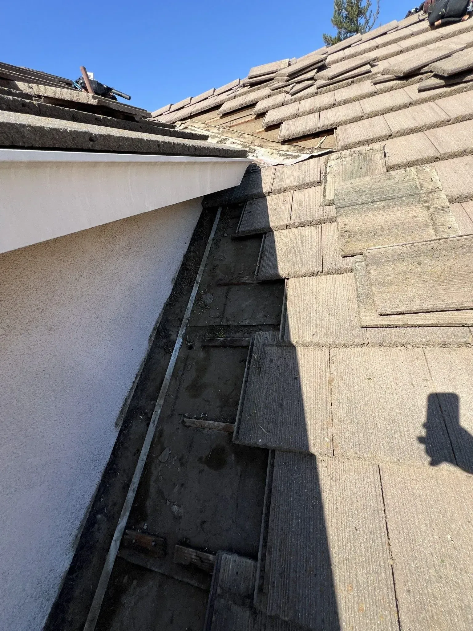 A close up of a roof with a drain on it.