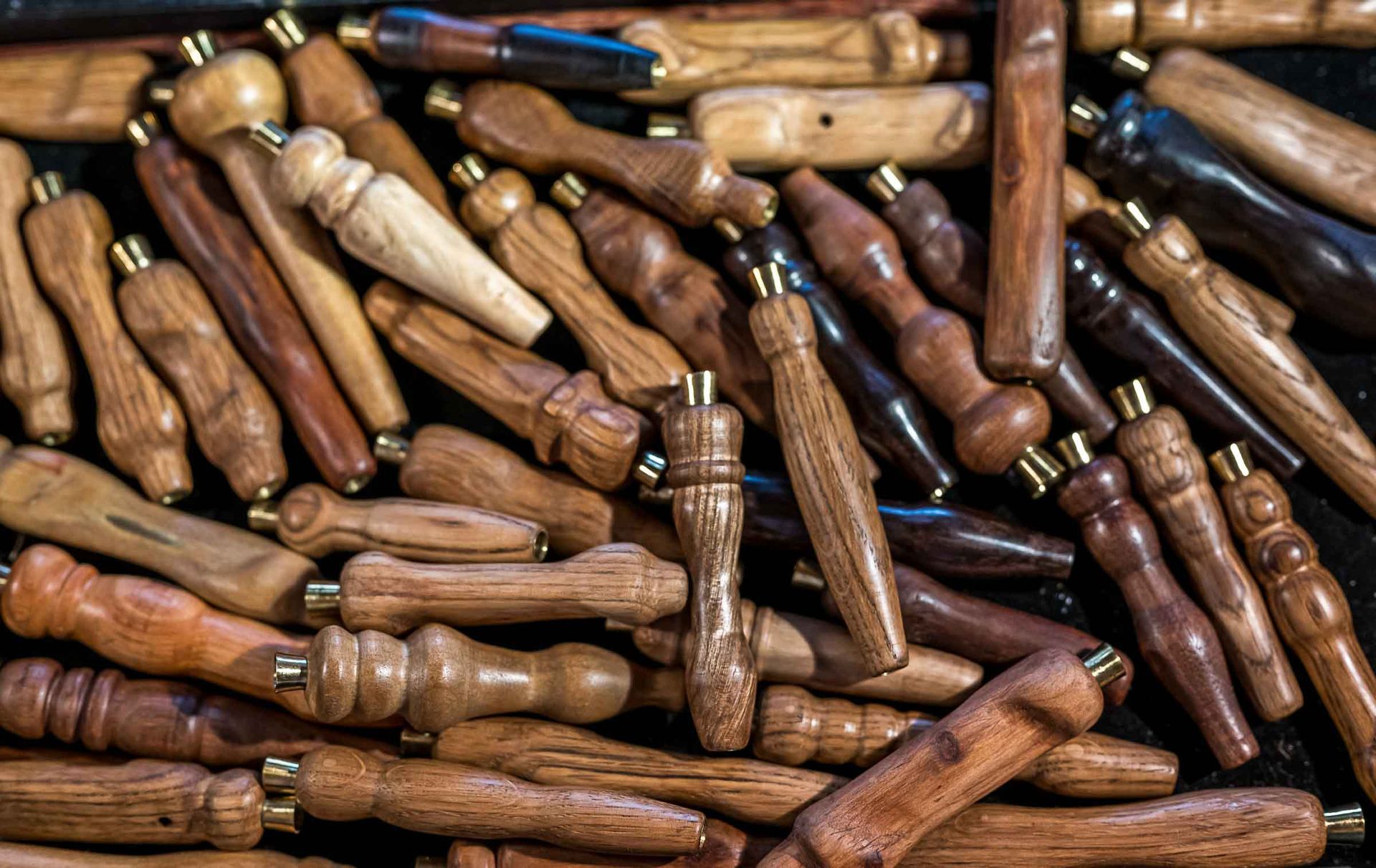 There are many different types of wooden handles in this pile.