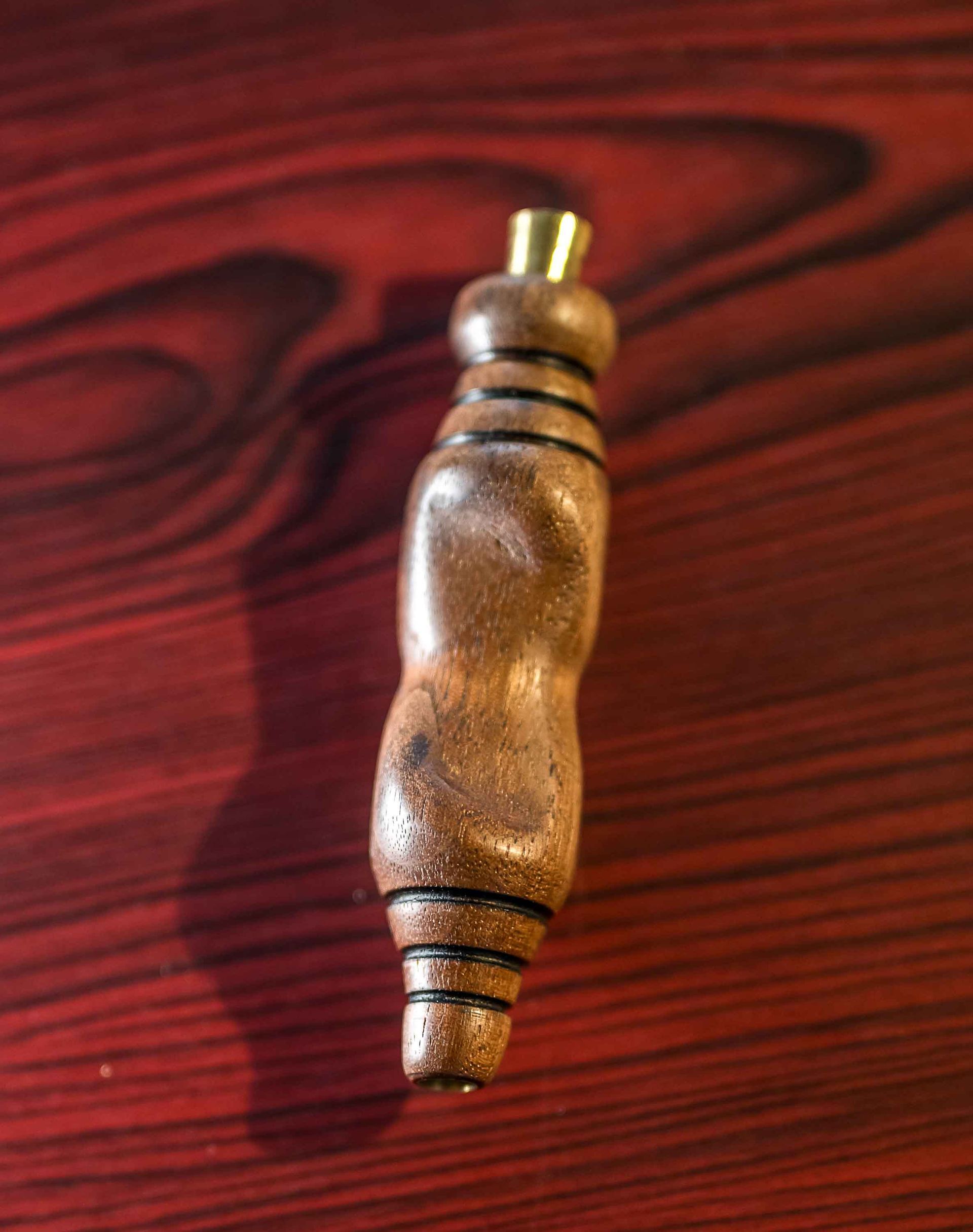 A wooden object is sitting on a wooden table