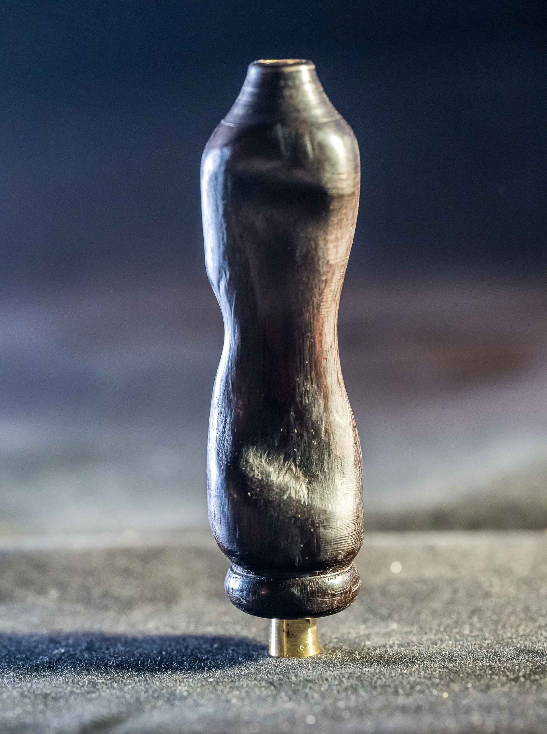 A small wooden object is sitting on a table.