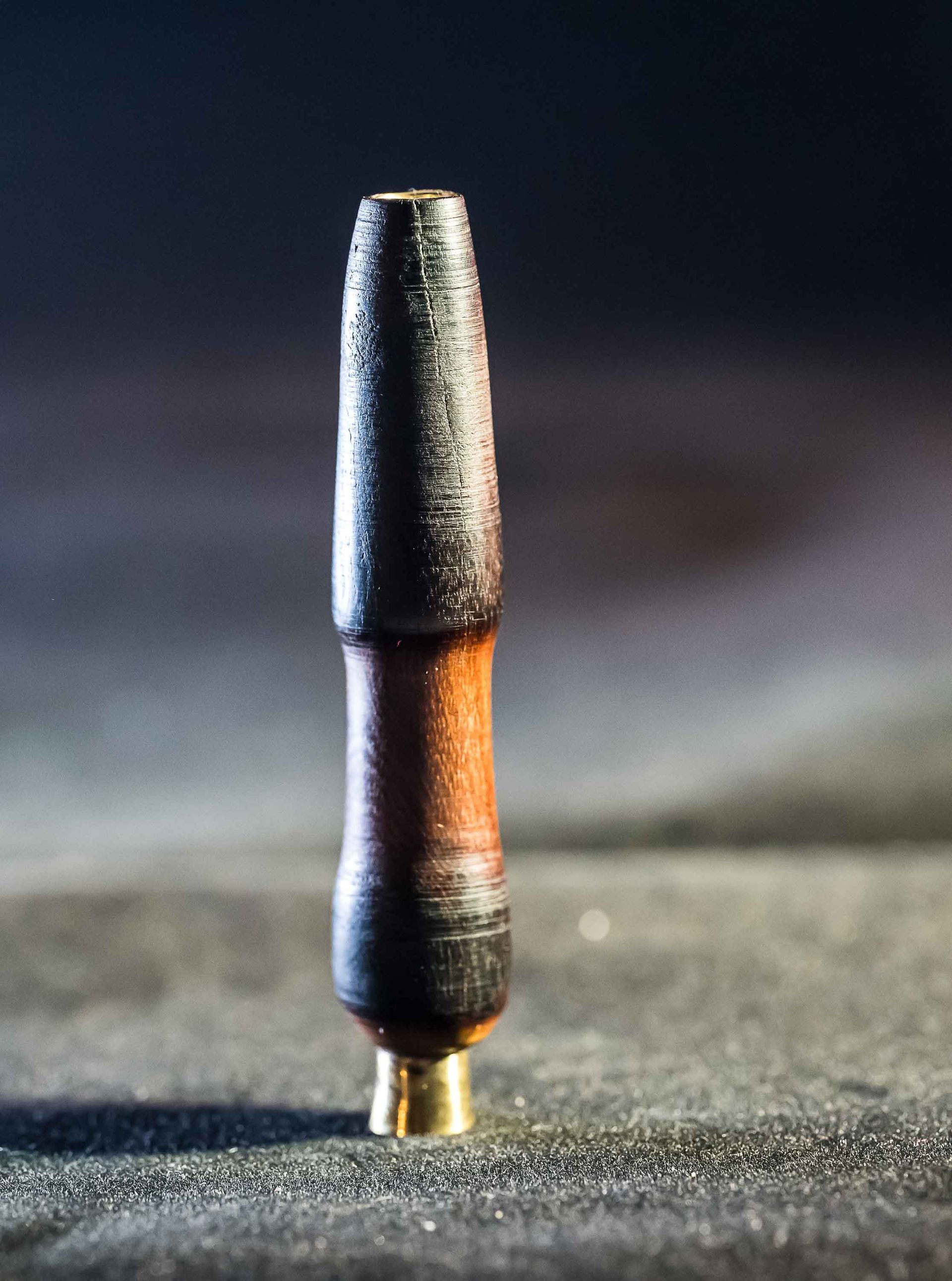A small wooden object is sitting on a table.