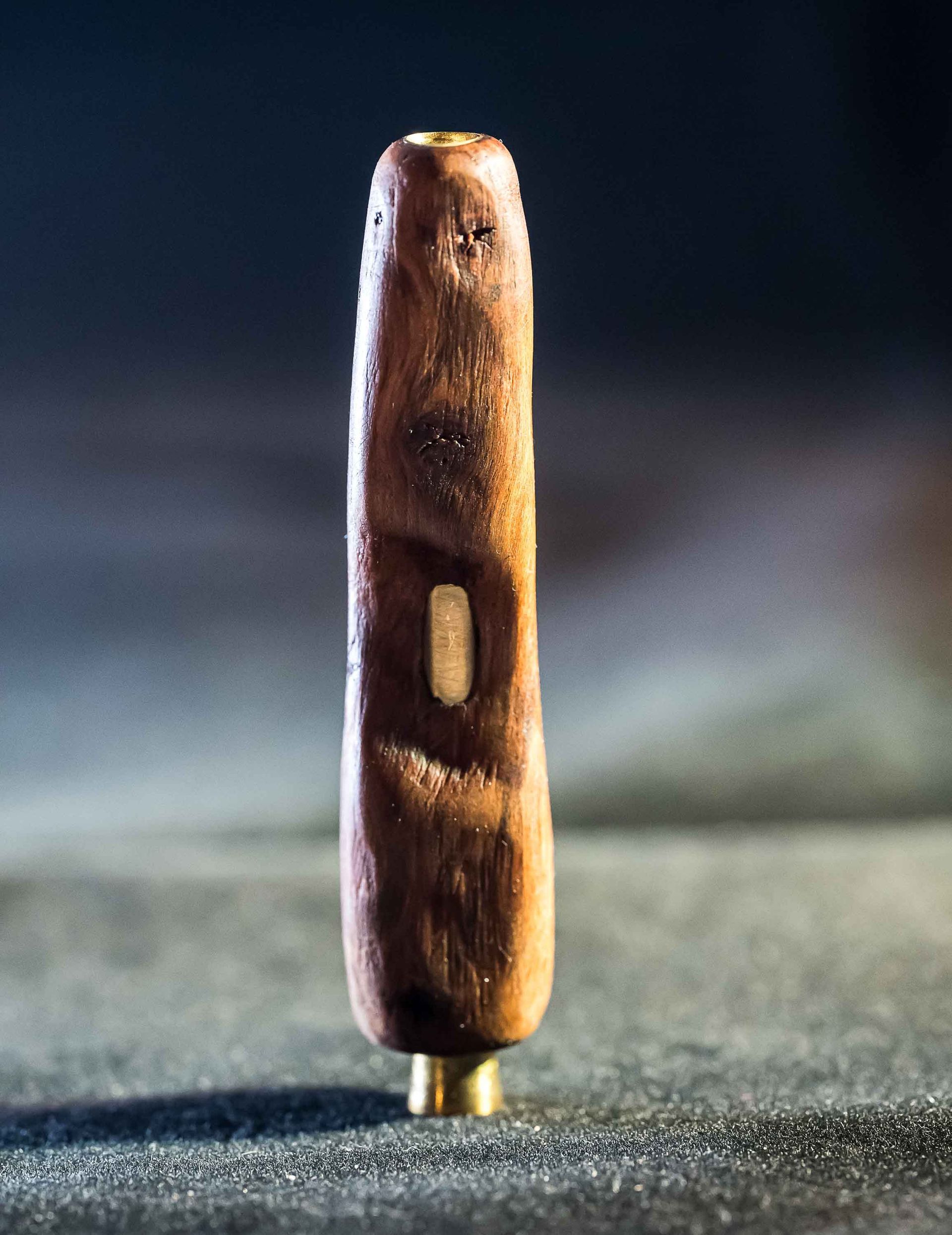 A wooden stick with a hole in the middle is sitting on a table.