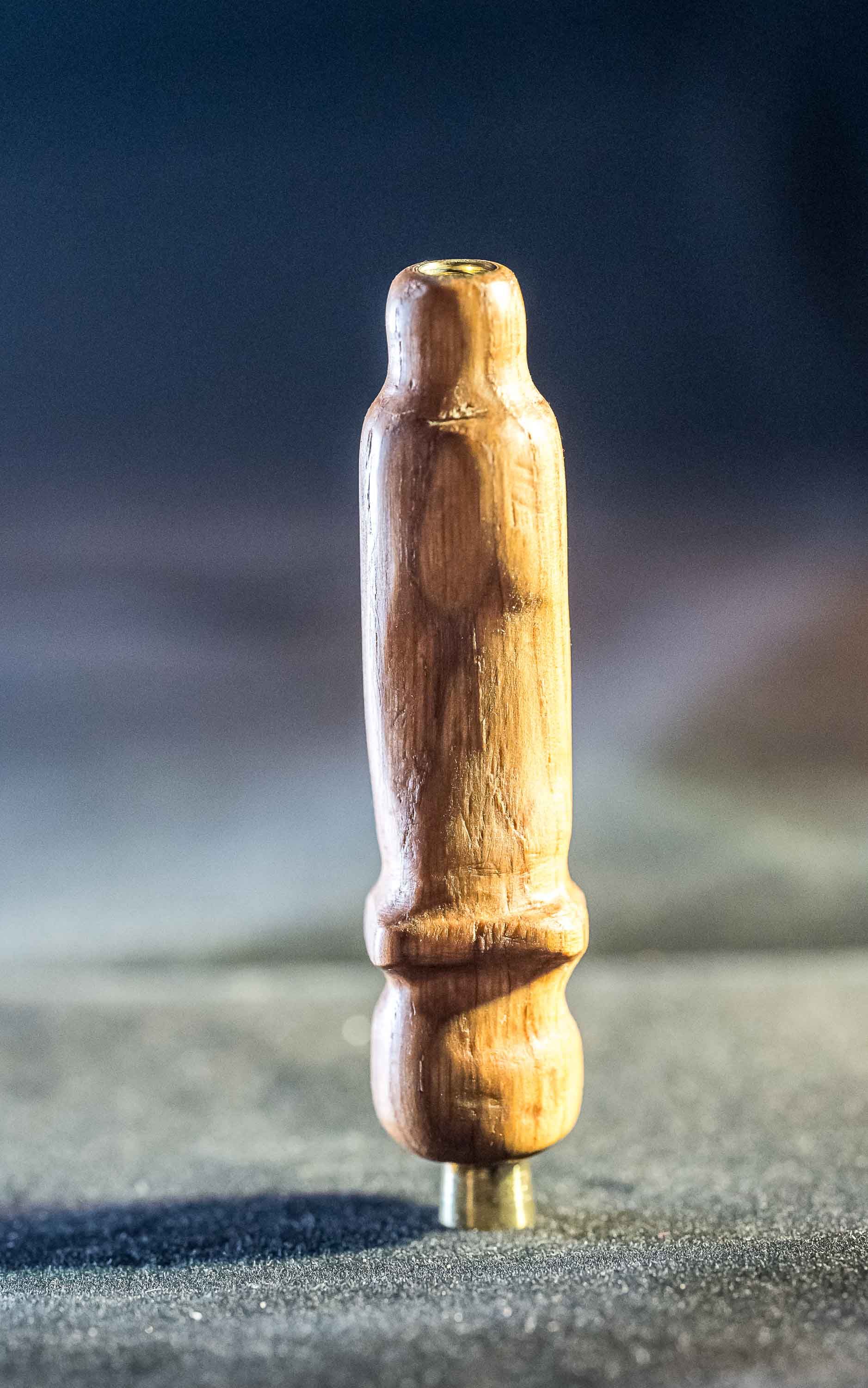 A small wooden stick is sitting on a table.