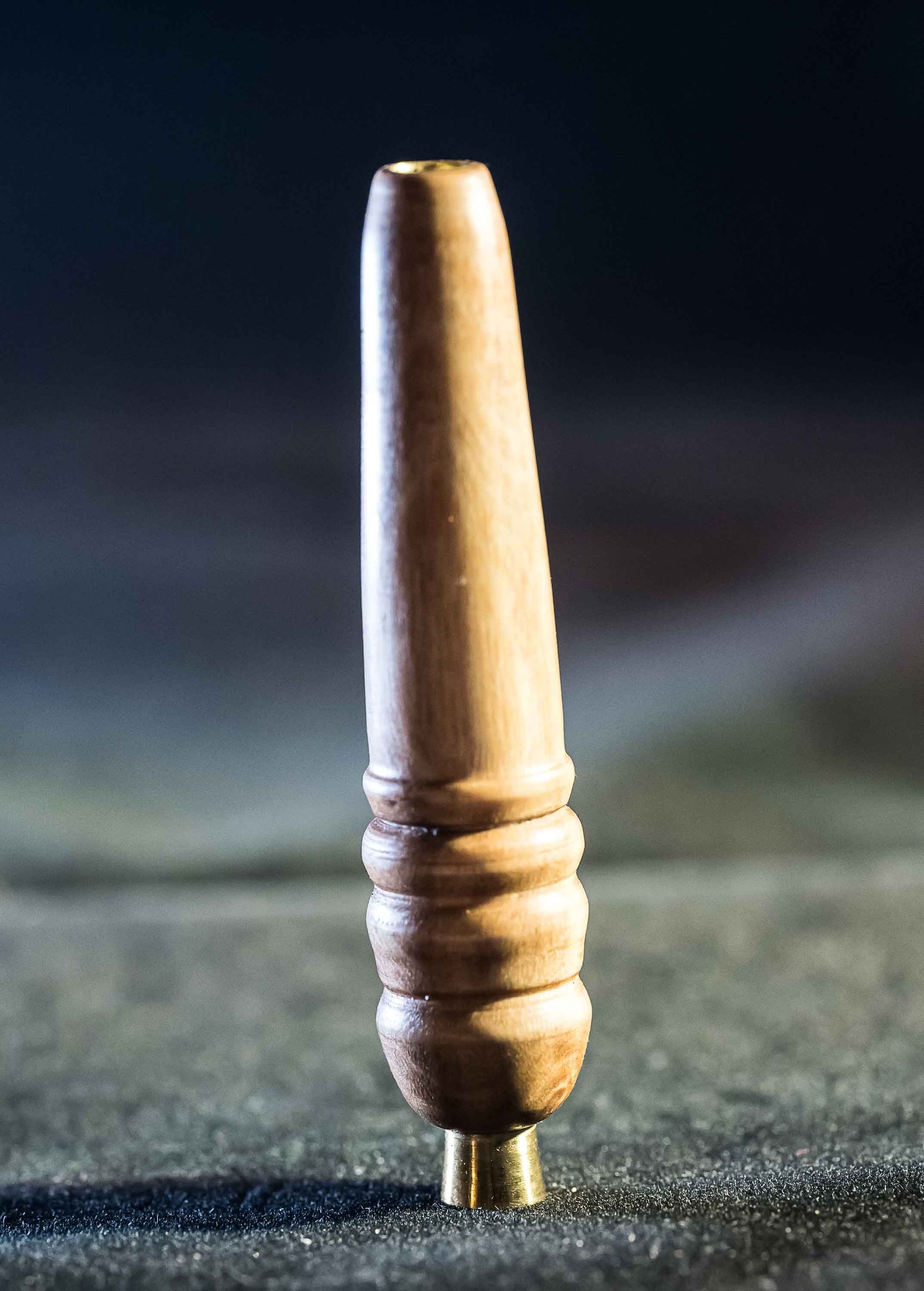 A small wooden object is sitting on a table.