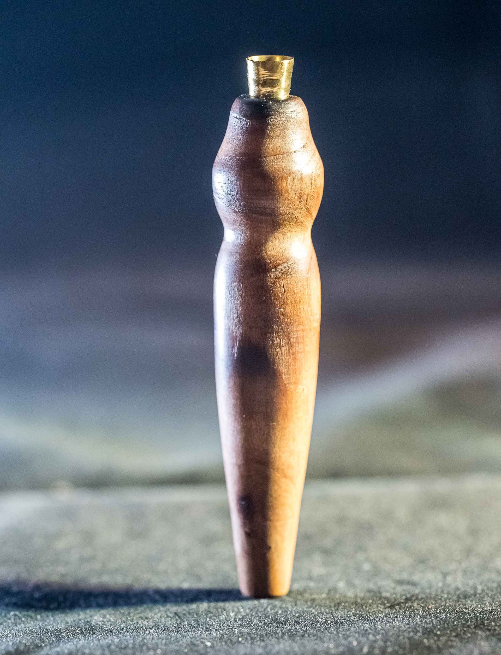 A wooden stick with a cork on top of it