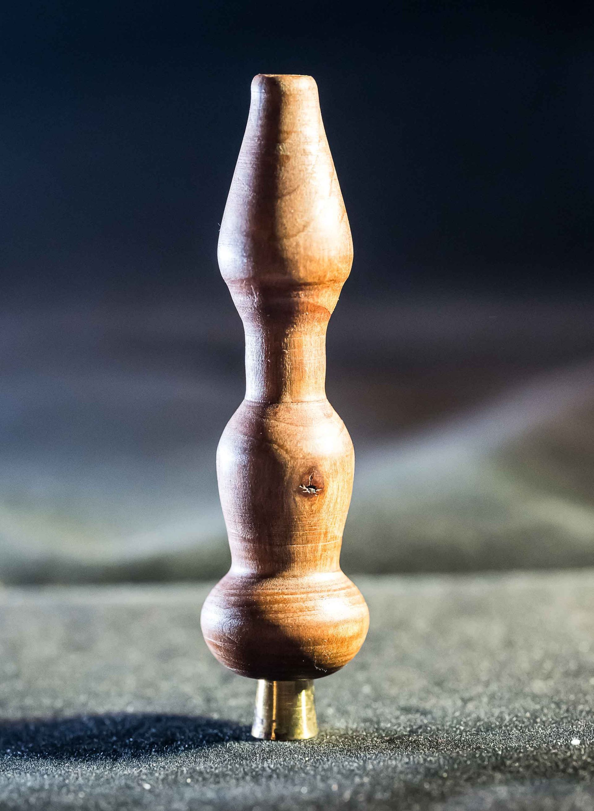 A small wooden object is sitting on a table.