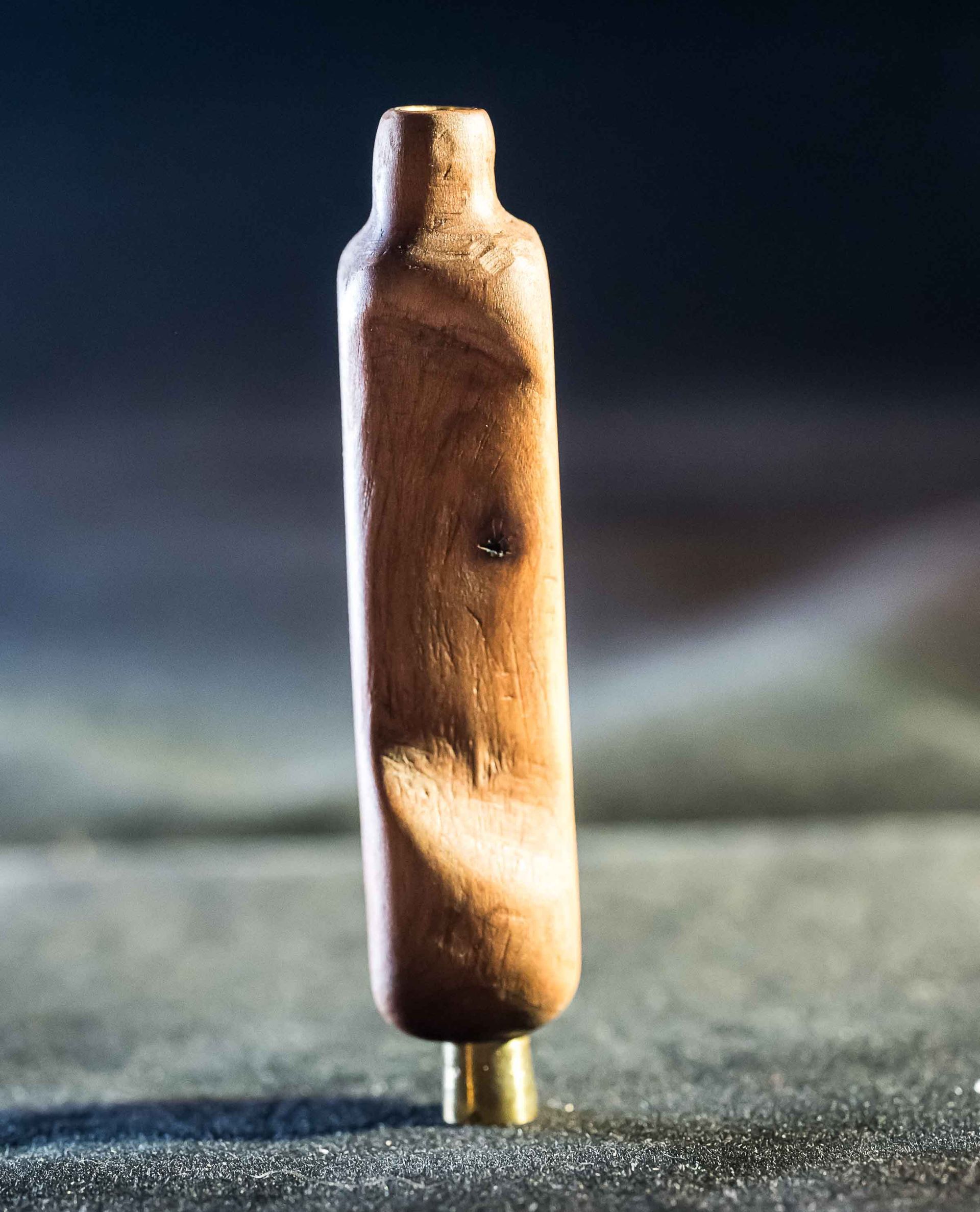 A small wooden object is sitting on a table.