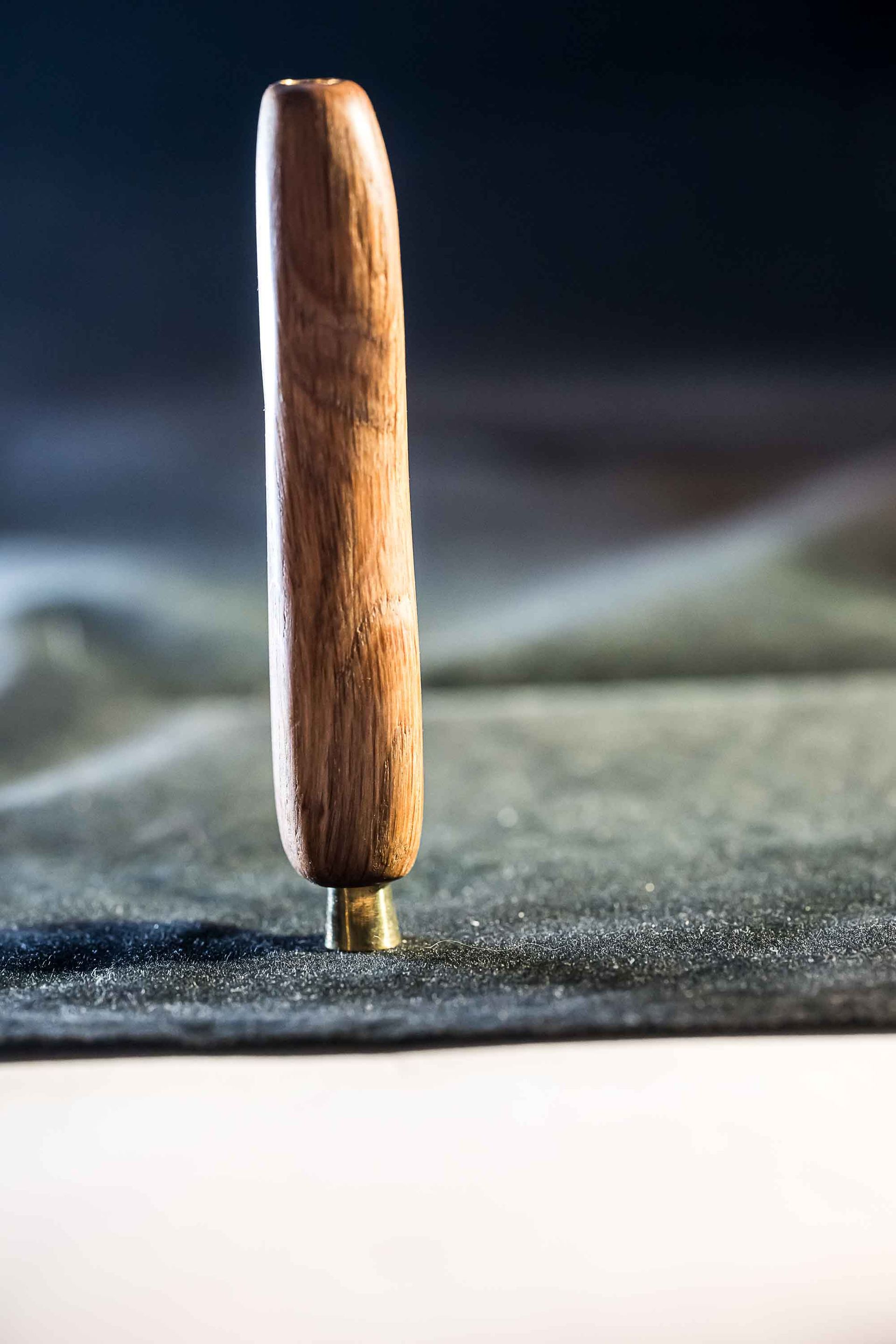 A close up of a wooden handle on a piece of paper.