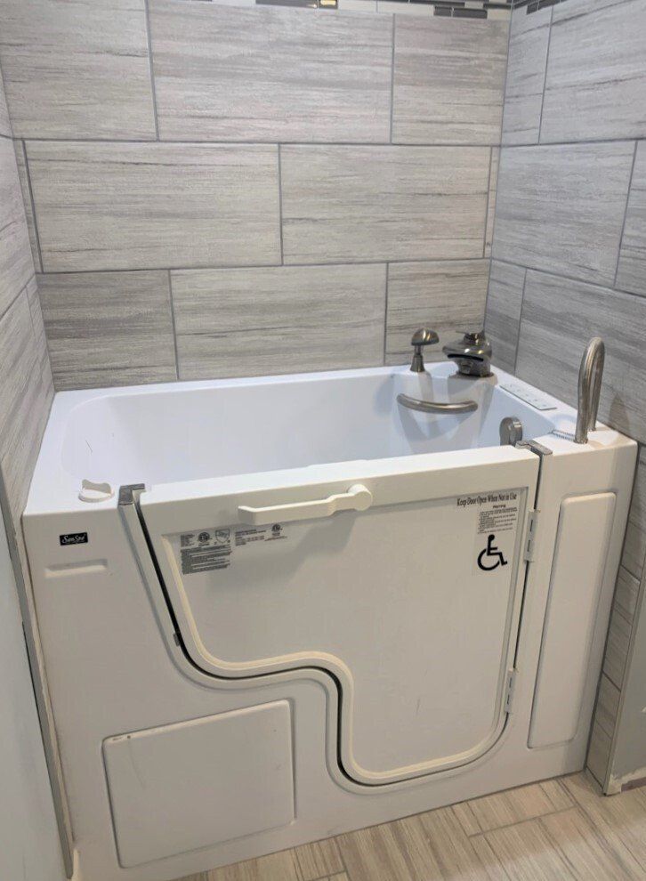 A walk in tub with a handicapped door in a bathroom.