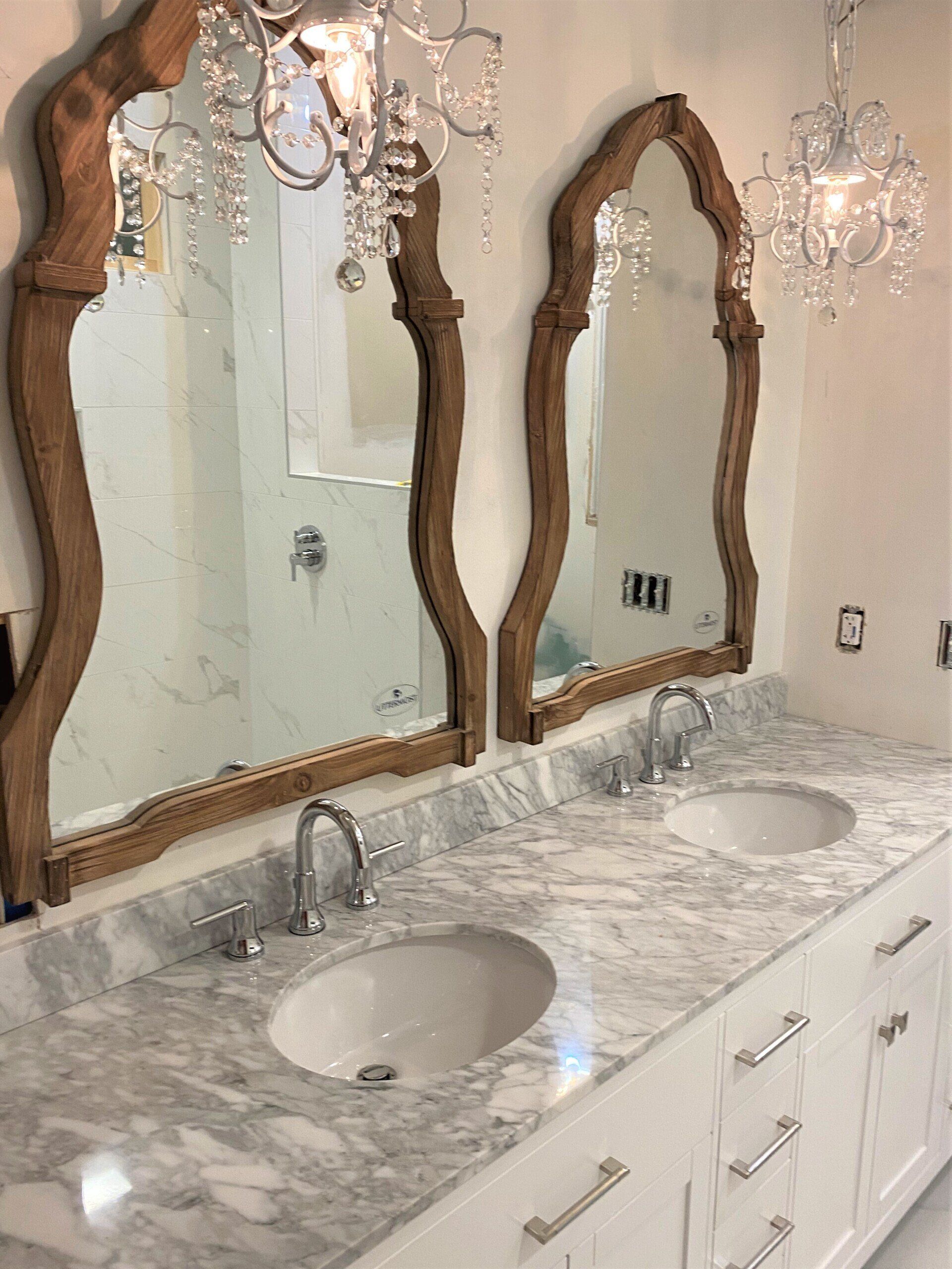 A bathroom with two sinks and two mirrors.