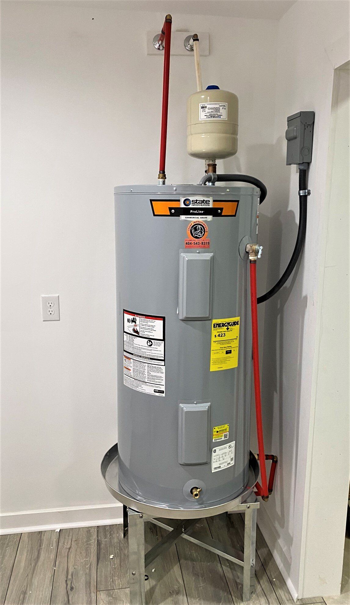 A water heater is sitting on top of a metal stand in a room.