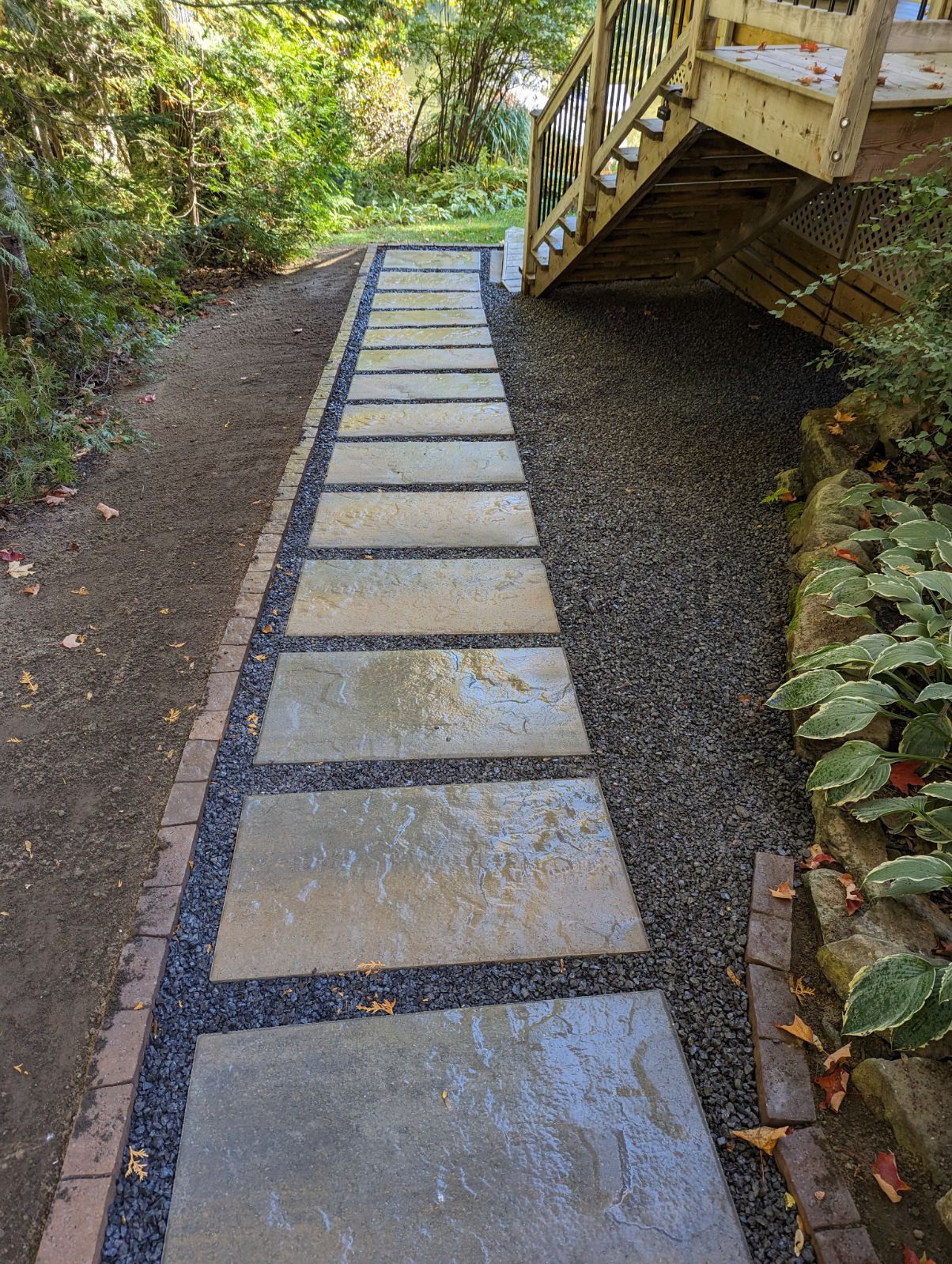 Une passerelle en pierre menant à une terrasse avec des escaliers.